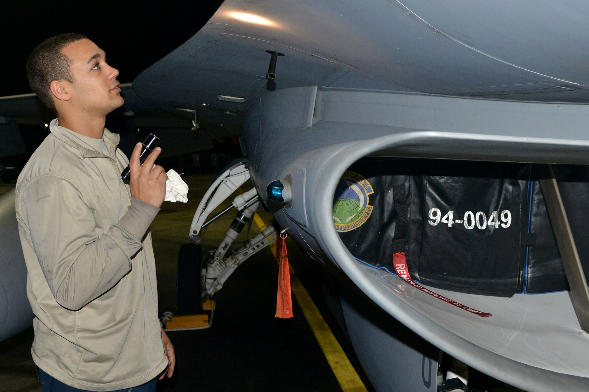 U.S. Air Force Senior Airman Tyler White, 20th Aircraft Maintenance Squadron tactical aircraft maintainer, examines the outer portion of F-16 Fighting Falcons to make sure there is nothing damaged, Shaw Air Force Base, S.C., Nov. 17, 2013. The maintainers at Shaw work day and night to keep the F-16 Fighting Falcons mission ready for combat ready airpower and Airmen at all times. (U.S. Air Force photo by Airman 1st Class Ashley L. Gardner/Released)