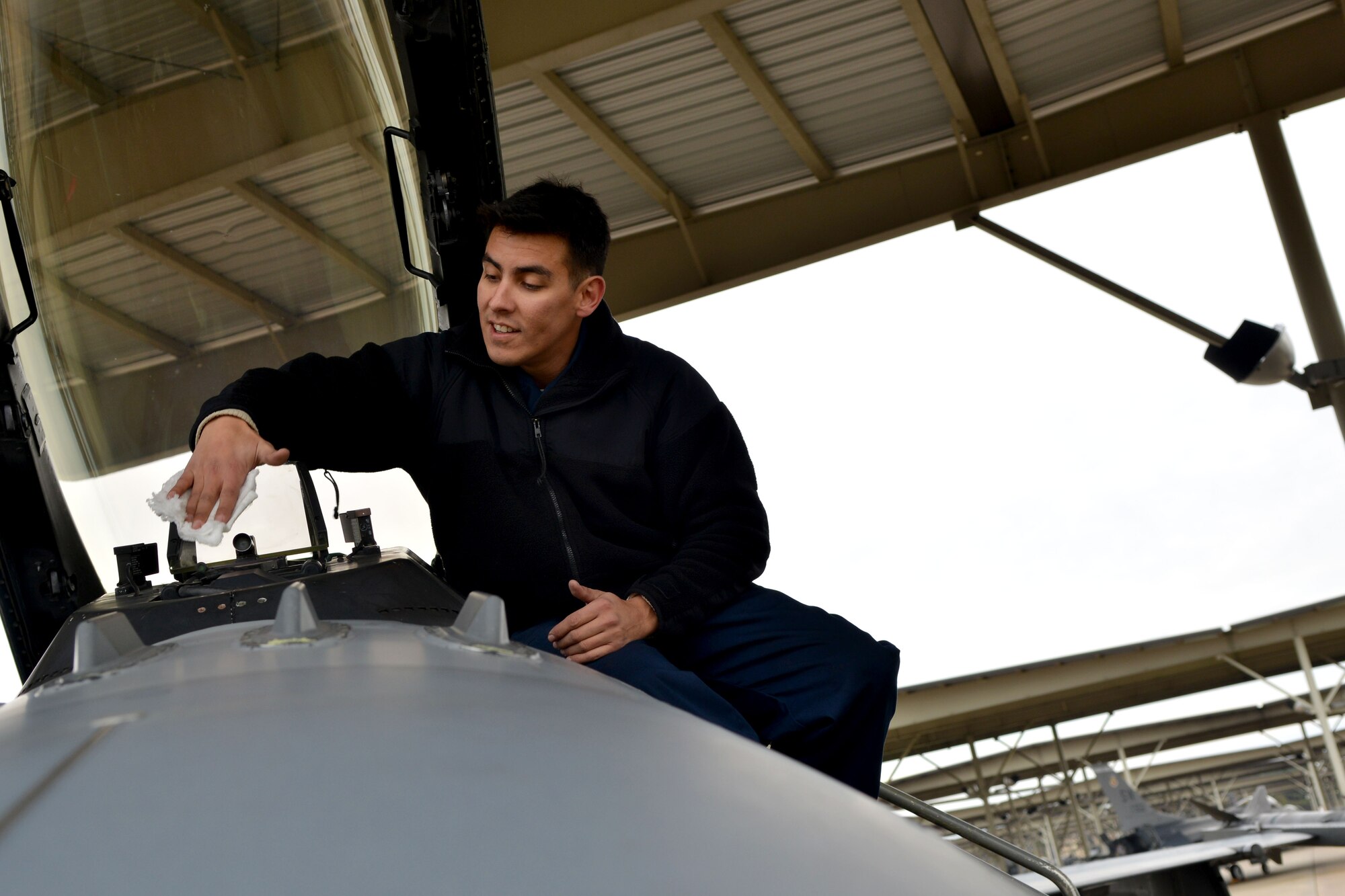 U.S. Air Force Staff Sgt. Anthony Gallegos, 20th Aircraft Maintenance Squadron tactical aircraft maintainer, cleans a F-16 Fighting Falcon to make sure there are no flying discrepancies, Shaw Air Force Base, S.C., Nov. 15, 2013. Along with ensuring the jets are mission ready, maintainers make sure the aircraft is clean so the pilot is able to see clearly. (U.S. Air Force photo by Airman 1st Class Ashley L. Gardner/Released)

