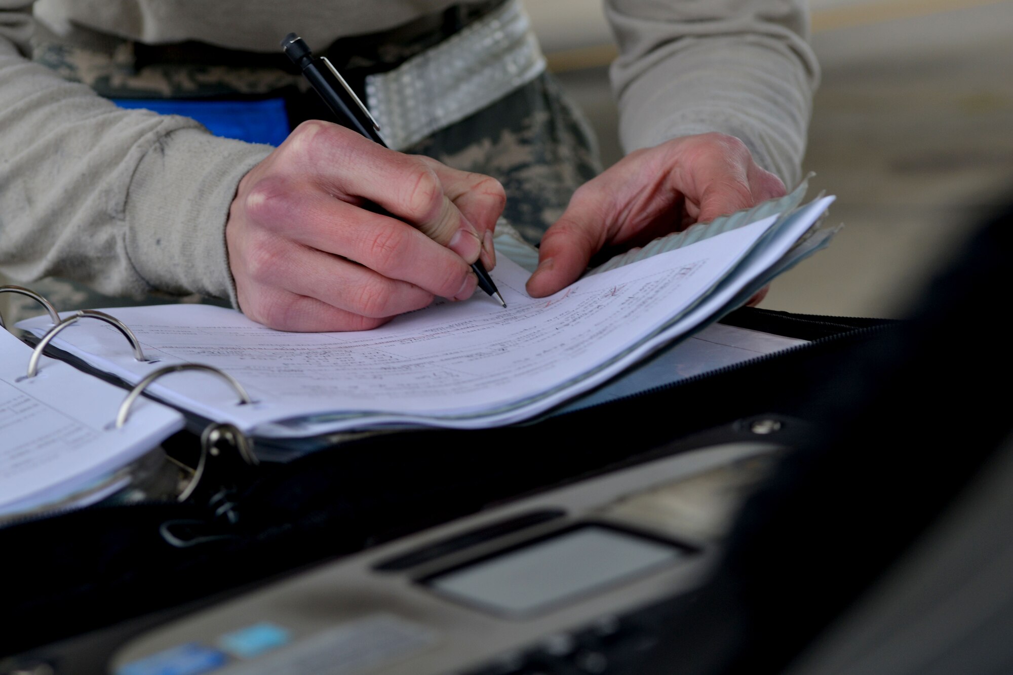 U.S. Air Force Senior Airman Matthew Hollenback, 20th Aircraft Maintenance Squadron tactical aircraft maintainer, writes down information during his routine jet check, Shaw Air Force Base, S.C., Nov. 15, 2013. To keep the F-16 Fighting Falcons in tip top shape, maintainers at Shaw endure long shifts during all types of weather in order to maintain a high level of mission capabilities. (U.S. Air Force photo by Airman 1st Class Ashley L. Gardner/Released)