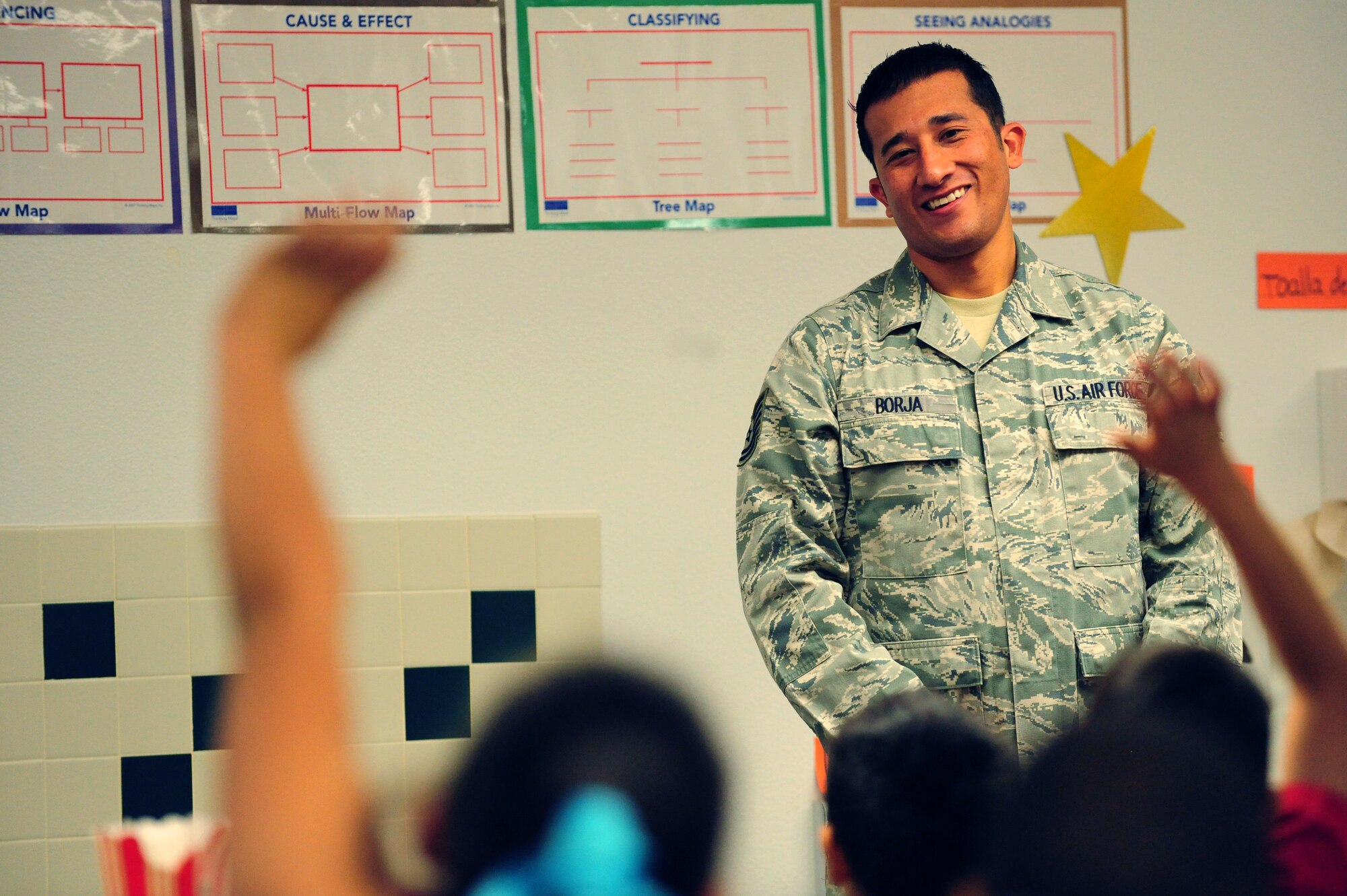 Tech. Sgt. Phillip Borja, 99th Logistics Readiness Squadron weapons vault supervisor, takes questions from students during his presentation Nov. 8, 2013 at Doris French Elementary School in Las Vegas. Following their presentations, Airmen took time to answer questions regarding life in the military and personal experiences. (U.S. Air Force photo by Airman 1st Class Joshua Kleinholz)