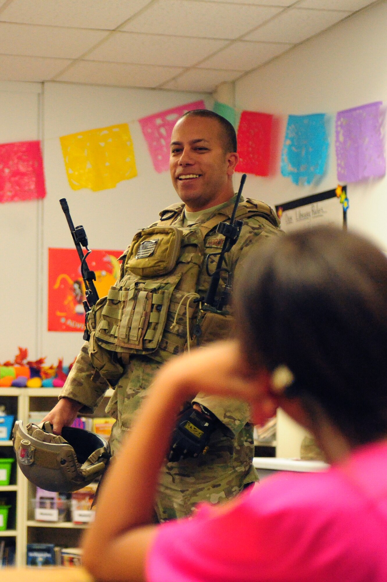 Tech. Sgt. Lawrence Dizon, 66th Weapons Squadron communications equipment technician, gives a presentation to fight grade students about his Air Force experiences during a Veteran’s Day celebration Nov. 8, 2013 at Doris French Elementary School in Las Vegas. Throughout the day, 16 Airmen rotated through classrooms giving presentations about their career fields and answering questions about life in the military. (U.S. Air Force photo by Airman 1st Class Joshua Kleinholz)