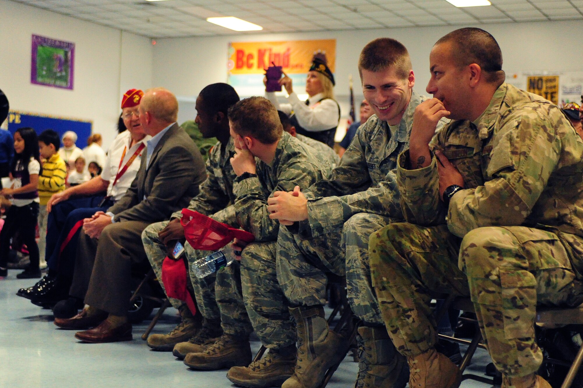 Airmen from Nellis and Creech Air Force Bases attend a Veterans Day assembly alongside other U.S. military veterans at Doris French Elementary School Nov. 8, 2013, in Las Vegas. Airmen responded to a volunteer opportunity that offered a chance for them to spend a day at the school interacting with students and faculty while taking part in festivities that honored America’s veterans. (U.S. Air Force photo by Airman 1st Class Joshua Kleinholz)