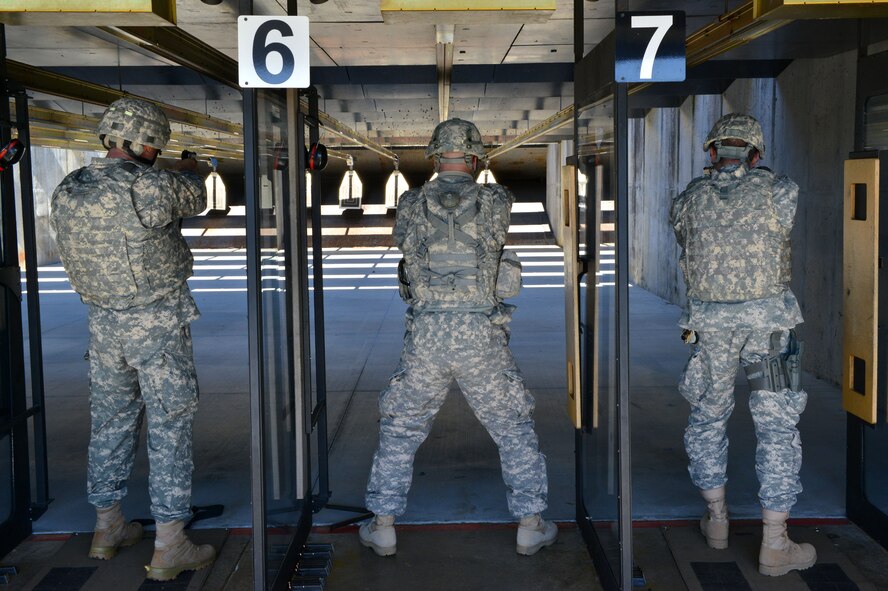 U.S. Army Soldiers fire M9 handguns during a "top shot" marksmanship competition at the 20th Security Forces Squadron Combat Arms and Training Maintenance firing range, Shaw Air Force Base S.C., on Nov. 14, 2013. Each of the nine competitors had one 10-round magazine to familiarize themselves with the weapon before the event started. (U.S. Air Force photo by Airman 1st Class Jensen Stidham/Released)
