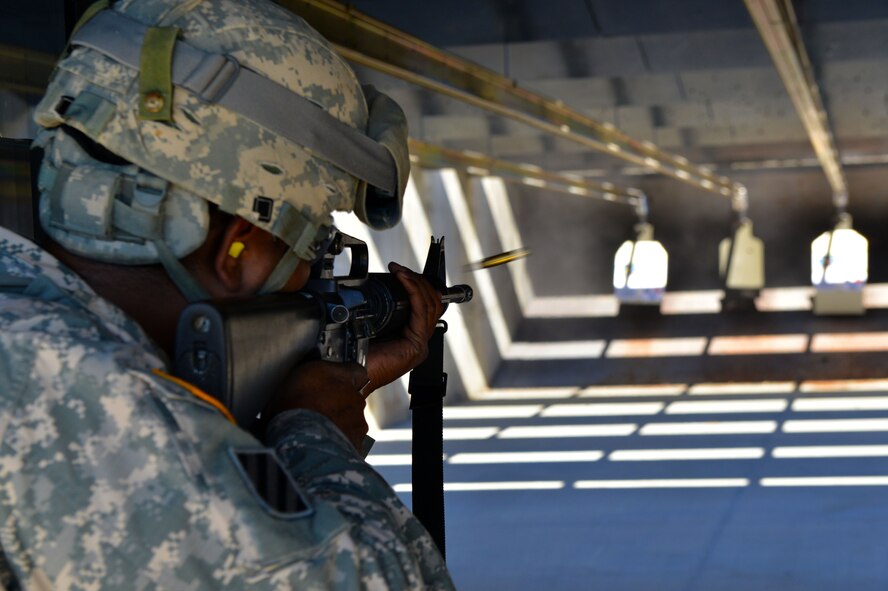 A U.S. Army Soldier fires an M16 rifle during a “top shot” marksmanship competition at the 20th Security Forces Squadron Combat Arms and Training Maintenance firing range, Shaw Air Force Base S.C., on Nov. 14, 2013.  Nine Soldiers competed for the title of “top shot” during the event, firing the M9 handgun and M16 rifle at 11 different types of targets. (U.S. Air Force photo by Airman 1st Class Jensen Stidham/Released)