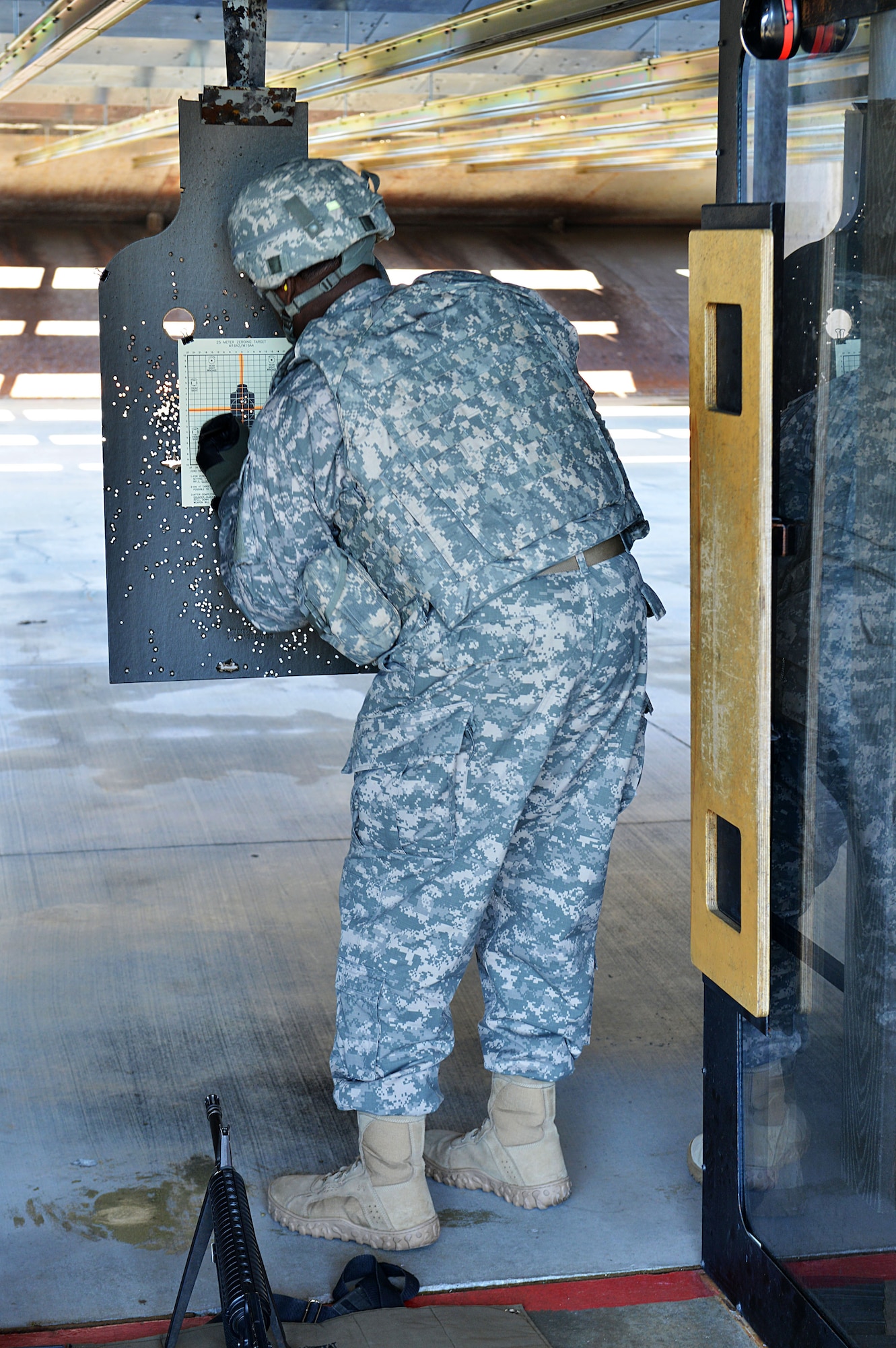 U.S. Army First Sergeant Mark Davis, 297th Military Intelligence Battalion, Charlie Company first sergeant, marks his target hits at the 20th Security Forces Squadron Combat Arms and Training Maintenance firing range, Shaw Air Force Base S.C., on Nov. 14, 2013. Participants used a variety of targets during the competition. (U.S. Air Force photo by Airman 1st Class Jensen Stidham)
