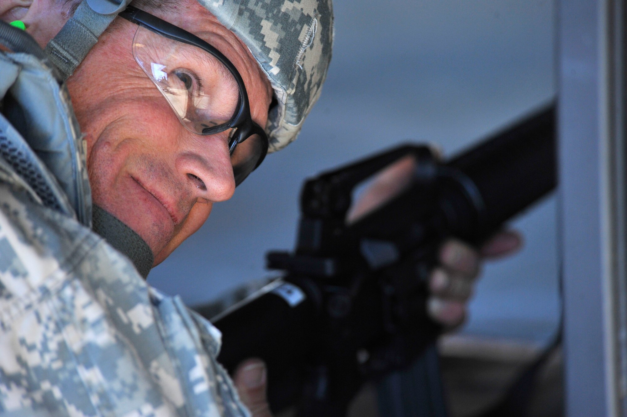 U.S. Army Chief Warrant Officer 5 Jeff Fraher, U.S. Army Central aviations safety officer, takes a moment to smile after firing his M16 rifle at the 20th Security Forces Squadron Combat Arms and Training Maintenance firing range, Shaw Air Force Base S.C., on Nov. 14, 2013. Fraher was participating in a “top shot” competition to test his marksmanship on an M16 and M9 handgun. (U.S. Air Force photo by Airman 1st Class Jensen Stidham/Released)