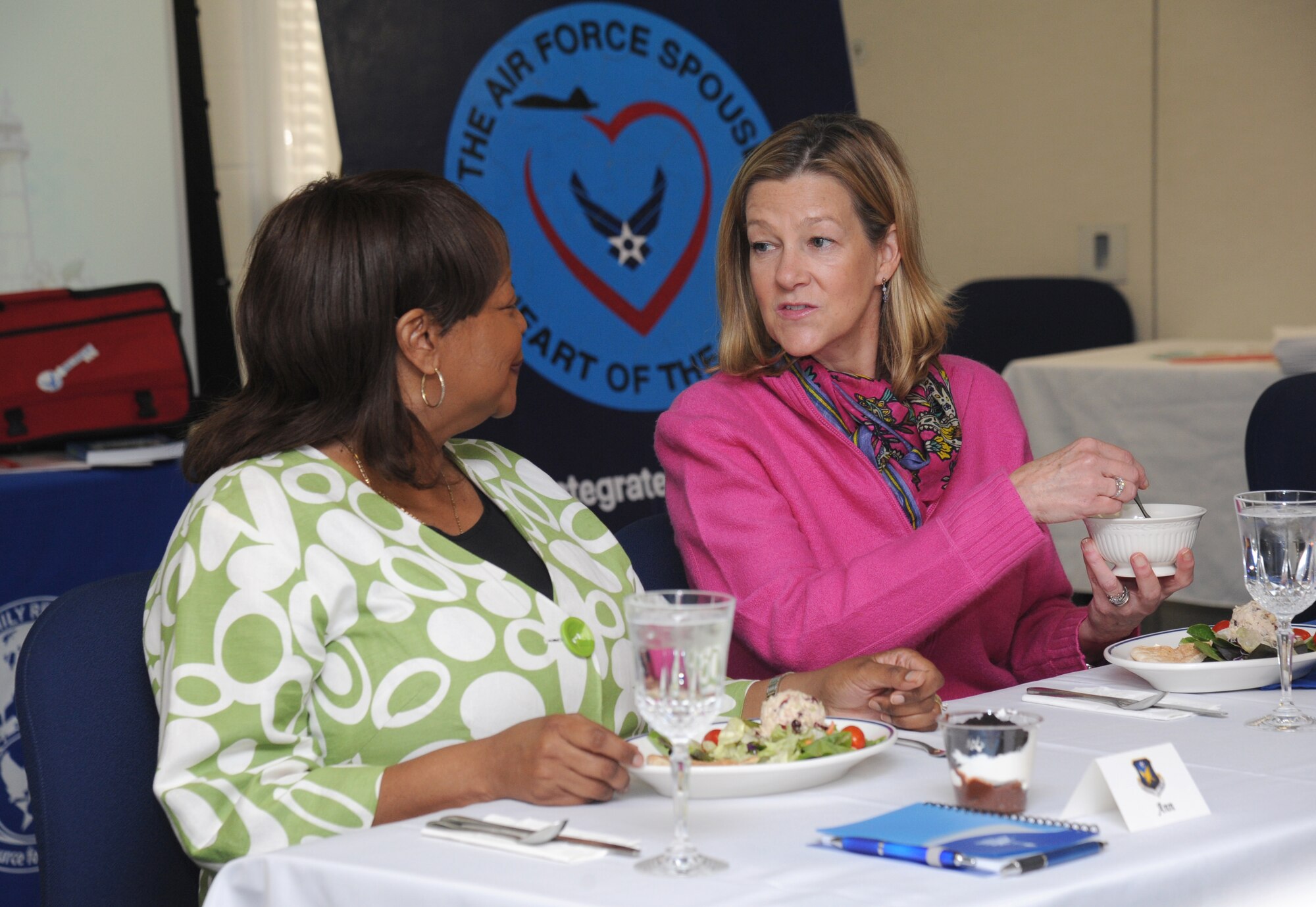 The wife of Col. Malcolm “TJ” Johnson, 2nd Air Force vice commander, speaks with the wife of Gen. Robin Rand, Air Education and Training Command commander, during a round table luncheon with Keesler spouses to discuss the key spouse program Nov. 14, 2013, at the Sablich Center, Keesler Air Force Base, Miss.  Rand was accompanied by Chief Master Sgt. Gerardo Tapia, AETC command chief, during a site visit to Keesler which also included three commander’s calls, and a tour of the Levitow Training Support Facility and 2nd Air Force headquarters. (U.S. Air Force photo by Kemberly Groue)