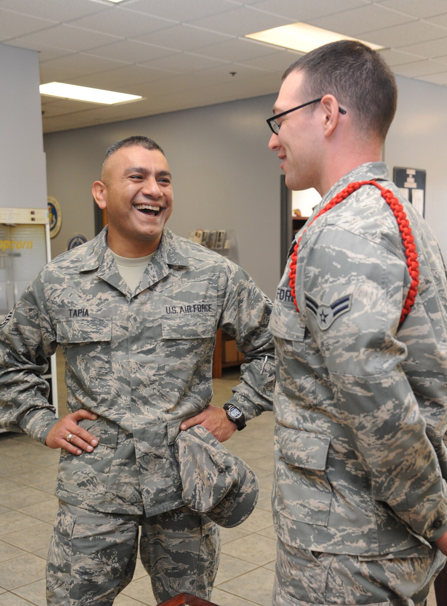 Chief Master Sgt. Gerardo Tapia, Air Education and Training Command command chief, shares a laugh with Airman 1st Class Austin Cooperrider, 338th Training Squadron, during a tour of the Fish Bowl at the Levitow Training Support Facility, Nov. 14, 2013, Keesler Air Force Base, Miss. Tapia accompanied Gen. Robin Rand, AETC commander, and Mrs. Rand to Keesler during a site visit. The visit also included three commander’s calls, and a tour of the Keesler Medical Center and 2nd Air Force headquarters. (U.S. Air Force photo by Kemberly Groue)