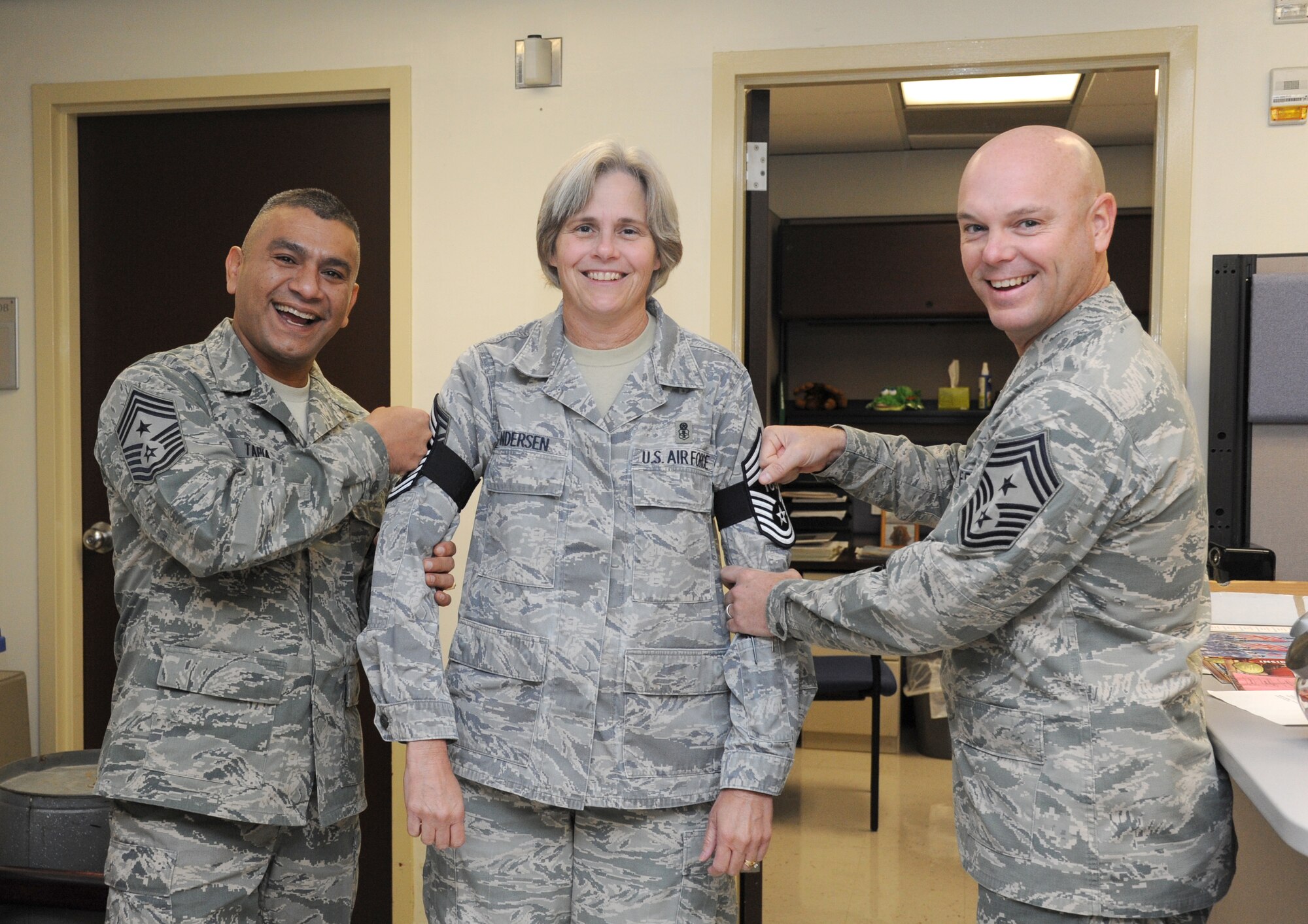 Chief Master Sgts. Gerardo Tapia, Air Education and Training Command command chief, and David Staton, 2nd Air Force command chief, congratulate Senior Master Sgt. Susan Andersen, 81st Diagnostic and Therapeutics Squadron, for being selected to the promotion of Chief Master Sergeant. Nov. 14, 2013, at the Keesler Medical Center, Keesler Air Force Base, Miss. Tapia accompanied Gen. Robin Rand, AETC commander, and his wife to Keesler during a visit which also included three commander’s calls, and a tour of the 81st Medical Group, the Levitow Training Support Facility and 2nd Air Force headquarters. (U.S. Air Force photo by Kemberly Groue)