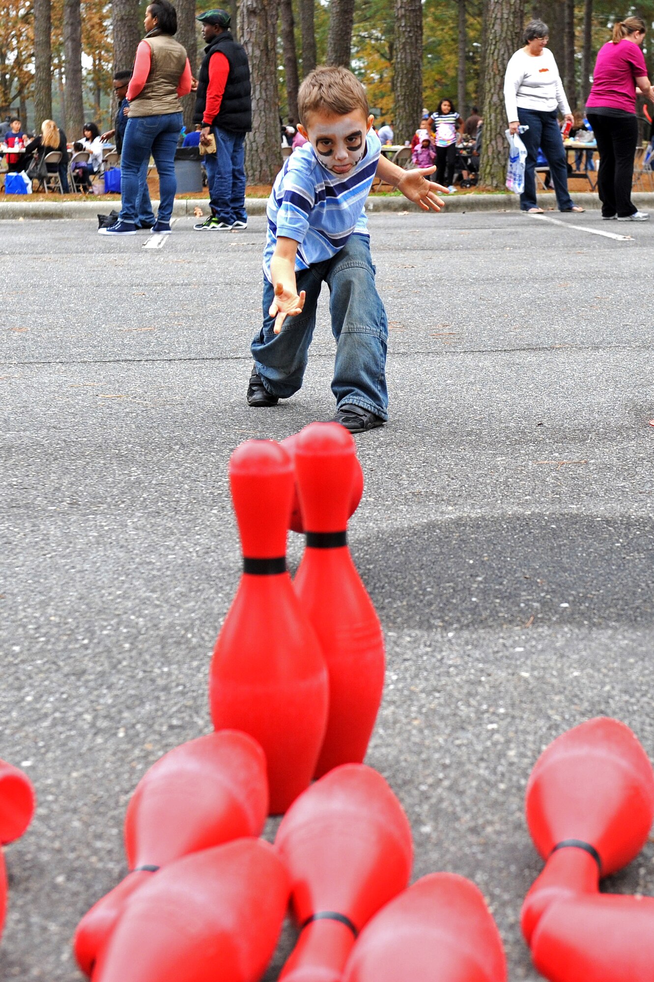 A member of Team Seymour demonstrates his bowling skills during the Month of the Military Family block party at Seymour Johnson Air Force Base, N.C., Nov. 16, 2013. The event was hosted by the Airman and Family Readiness Center with support from many volunteers within the community to honor military families. (U.S. Air Force photo by Airman 1st Class Aaron J. Jenne)