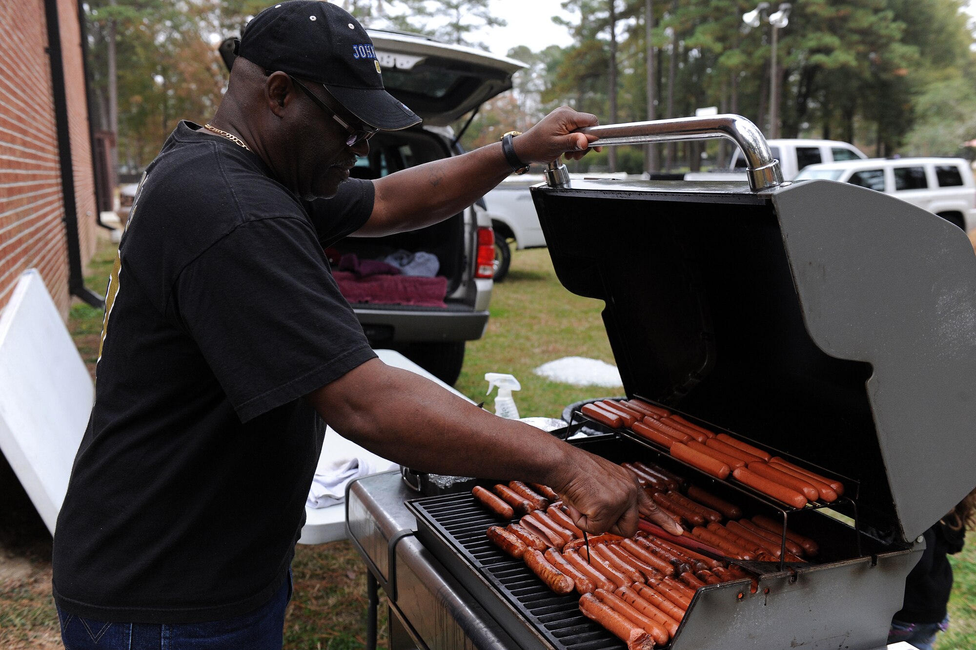 Jay Jenkins, Airman and Family Readiness Center community readiness specialist, grills hotdogs during the Month of the Military Family block party at Seymour Johnson Air Force Base, N.C., Nov. 16, 2013. More than 450 participants attended this year’s event. (U.S. Air Force photo by Airman 1st Class Aaron J. Jenne)