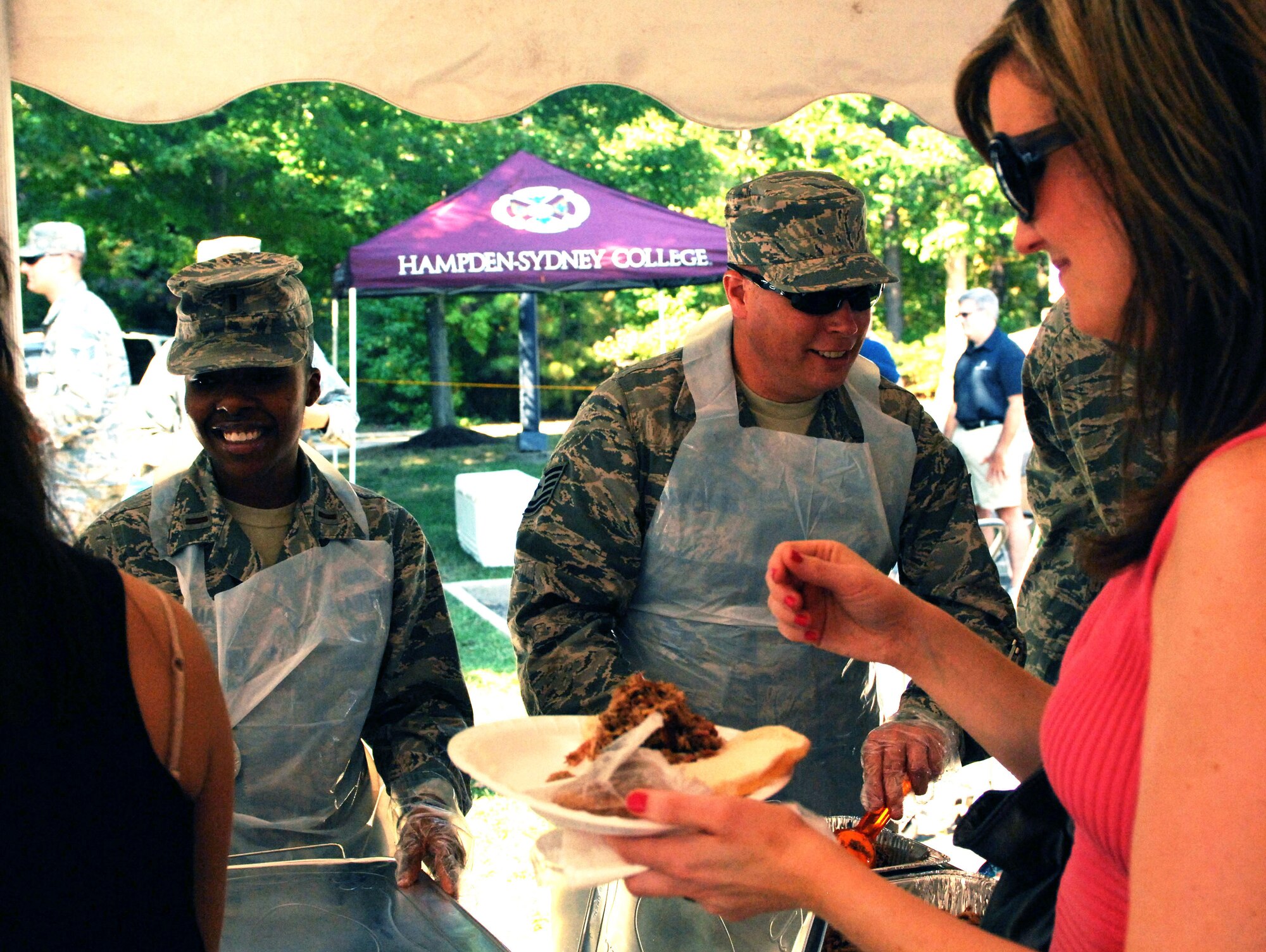 More than 60 Airmen from Langley Air Force Base volunteered their time helping with set-up, parking, cooking and serving at the Wounded Warriors Barbecue in Newport News, Va., Oct. 4, 2013.  Proceeds from the barbecue benefitted the Wounded Warriors Project.  (U.S. Air Force photo by 2nd Lt. Brooke Betit/Released)