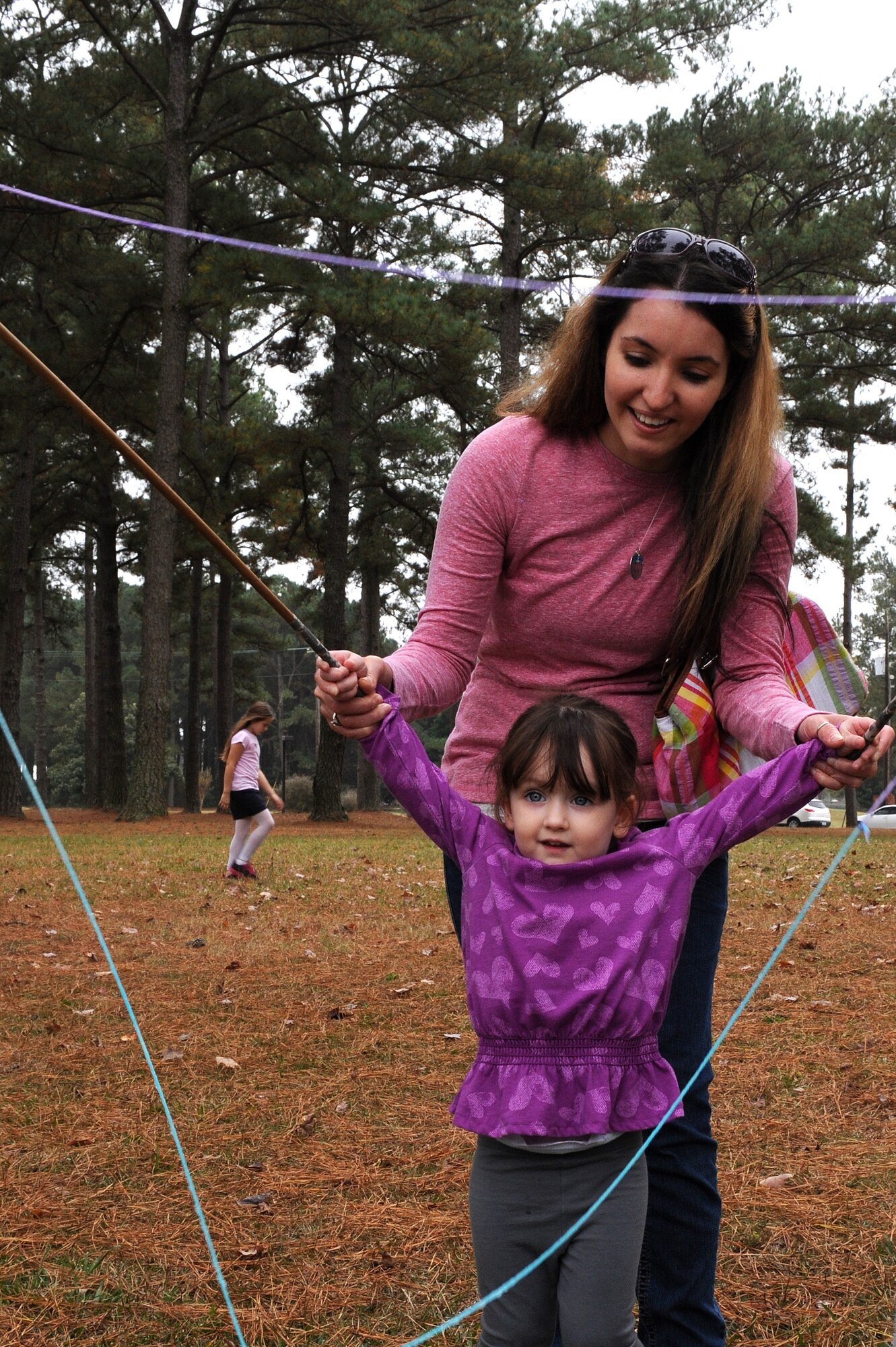 Members of Team Seymour attempt to create a large bubble during the Month of the Military Family block party at Seymour Johnson Air Force Base, N.C., Nov. 16, 2013. Members of the USO, Airman and Family Readiness Center and other volunteers provided bubble blowing, games and food to participants. (U.S. Air Force photo by Airman 1st Class Aaron J. Jenne)