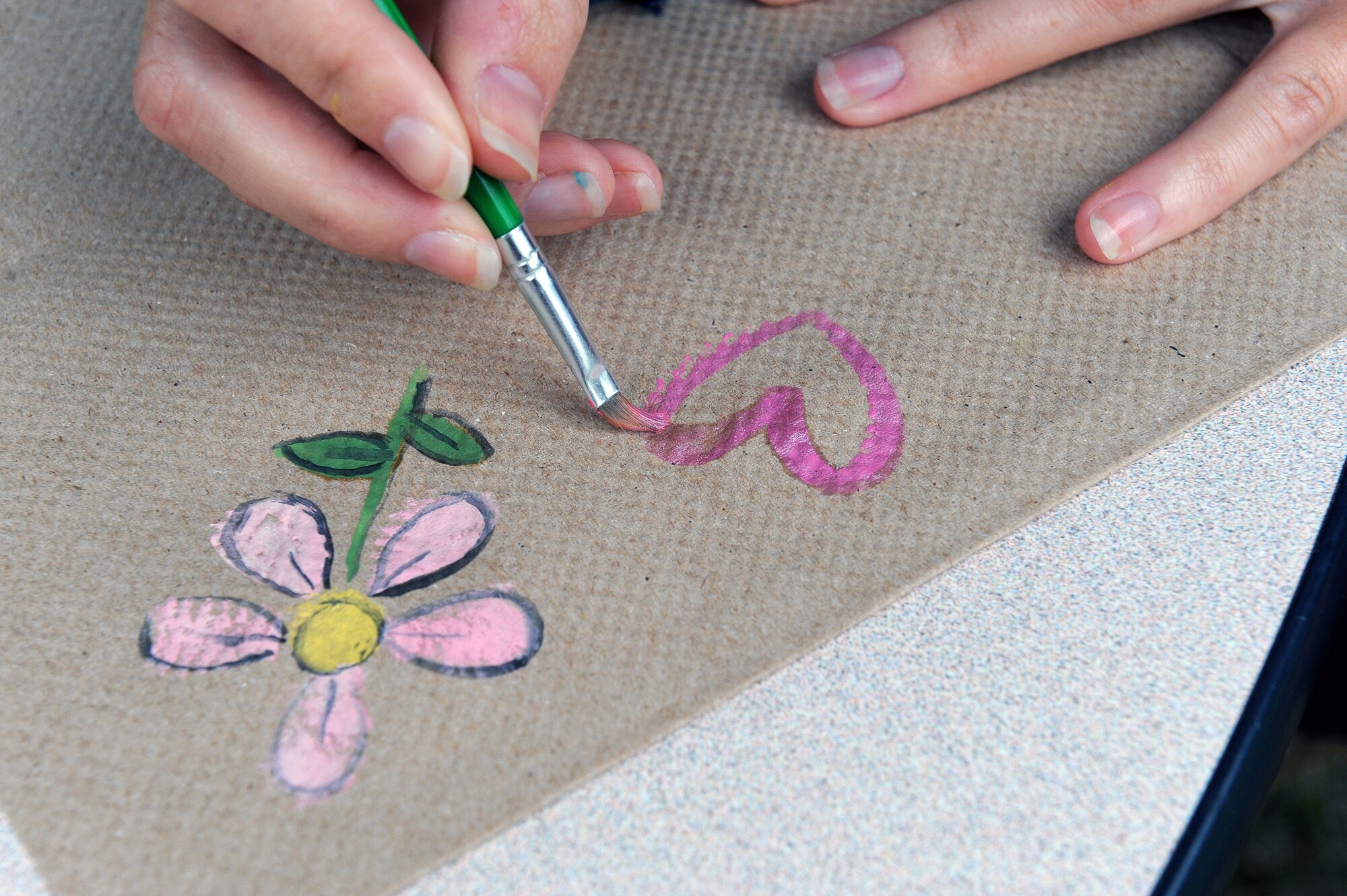 Alanna Liebhart, a Team Seymour volunteer, prepares to paint children’s faces during the Month of the Military Family block party at Seymour Johnson Air Force Base, N.C., Nov. 16, 2013. November was coined Military Family Appreciation Month by the Armed Services YMCA in 1993. (U.S. Air Force photo by Airman 1st Class Aaron J. Jenne)