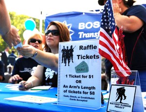 More than 50 local business employees supported the Wounded Warriors Barbecue in Newport News, Va., Oct. 4, 2013. Overall, the barbecue raised $10,000 in support of the Wounded Warriors Project. (U.S. Air Force photo by 2nd Lt. Brooke Betit/Released)