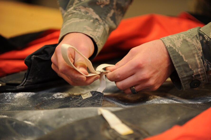 U.S. Air Force Senior Airman Eric Blanton, 7th Operations Support Squadron, tightens down a strap while inspecting a life raft Nov. 18, 2013, at Dyess Air Force Base, Texas. When Blanton was diagnosed with type-one diabetes, his blood sugar was six times greater than what it should have been. (U.S. Air Force photo by Airman 1st Class Autumn Velez/Released)