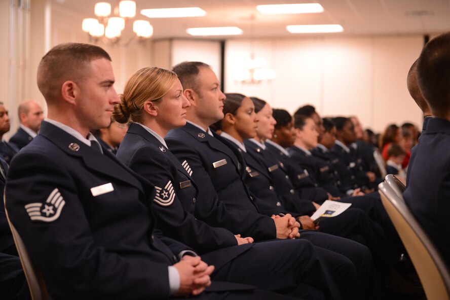 Airmen listen to remarks during their Community College of the Air Force graduation at Shaw Air Force Base, S.C., on Nov. 14, 2013. In 2013, 325 Airmen from Shaw earned their degrees, 61 of whom received formal recognition during the ceremony. (U.S. Air Force photo by Senior Airman Tabatha Zarrella/Released)
