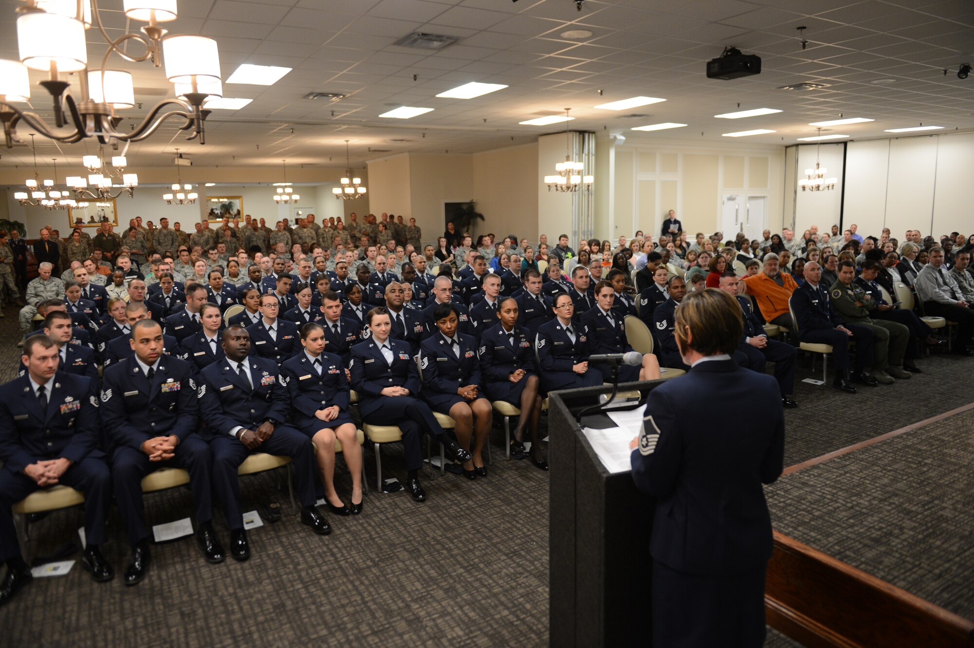 The Community College of the Air Force graduating class at Shaw Air Force Base, S.C., listens to the key note speech at the graduation ceremony at Shaw Air Force Base, S.C., on Nov. 14, 2013. The CCAF gives service members the opportunity to earn associate degrees related to their career fields in the Air Force. U.S. Air Force photo by Senior Airman Tabatha Zarrella/Released)