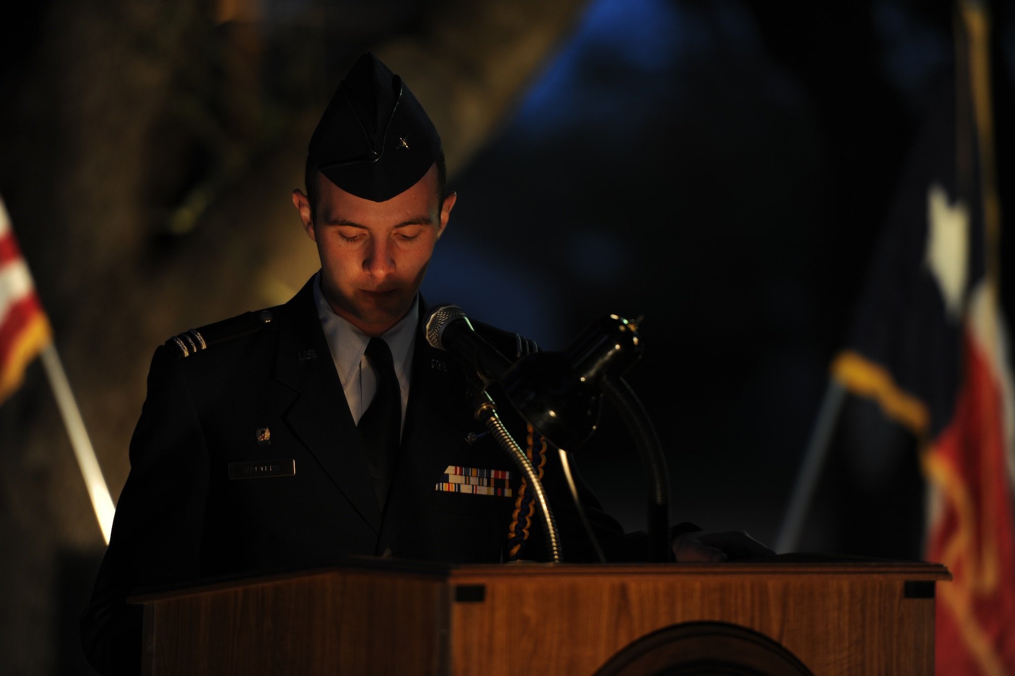 SAN ANGELO, Texas -- Angelo State University ROTC Cadet Evan Walters reads a biography of one of the 30 ASU graduates who gave their lives for their country in World War II during the candlelight vigil portion of the Veterans’ Vigil at the Angelo State University’s Oak Grove Memorial Nov. 13. ASU cadets read short biographies, letters written to or by family members or poems written in memory of the ASU alumni veterans every ten minutes until midnight. (U.S. Air Force photo/ Staff Sgt. Laura R. McFarlane)