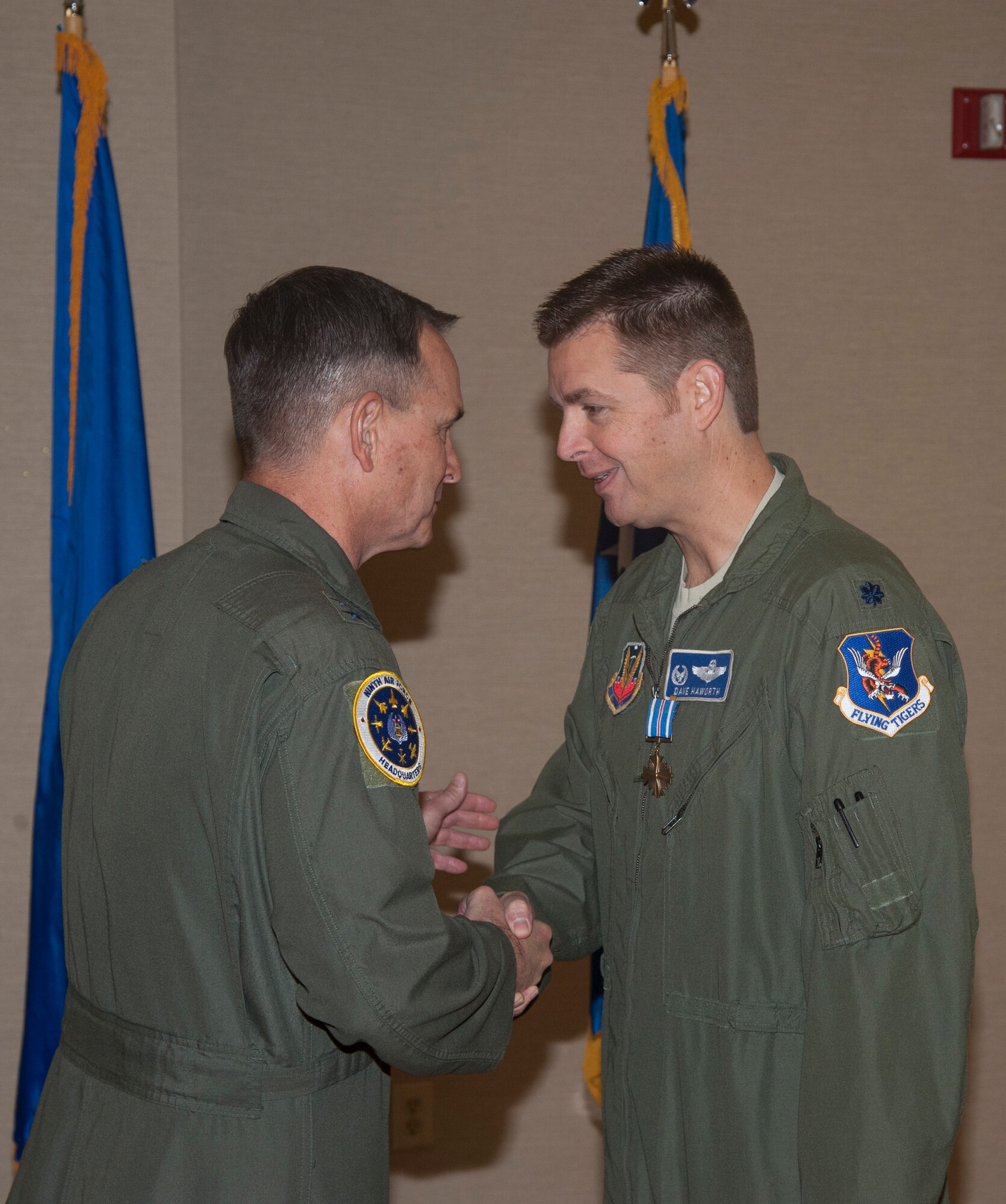 U.S. Air Force Maj. Gen. Jake Polumbo, Ninth Air Force commander, presents Lt. Col. David Haworth, A-10C Thunderbolt II pilot and former 74th Fighter Squadron commander, with the Distinguished Flying Cross at Moody Air Force Base, Ga., Nov. 14, 2013. Haworth earned the DFC through extraordinary achievement during a combat mission in which he coordinated efforts that saved nearly 60 U.S. personnel and enabled the recovery of a downed flight crew in April 2011. (U.S. Air Force photo by Airman Dillian Bamman/Released)
