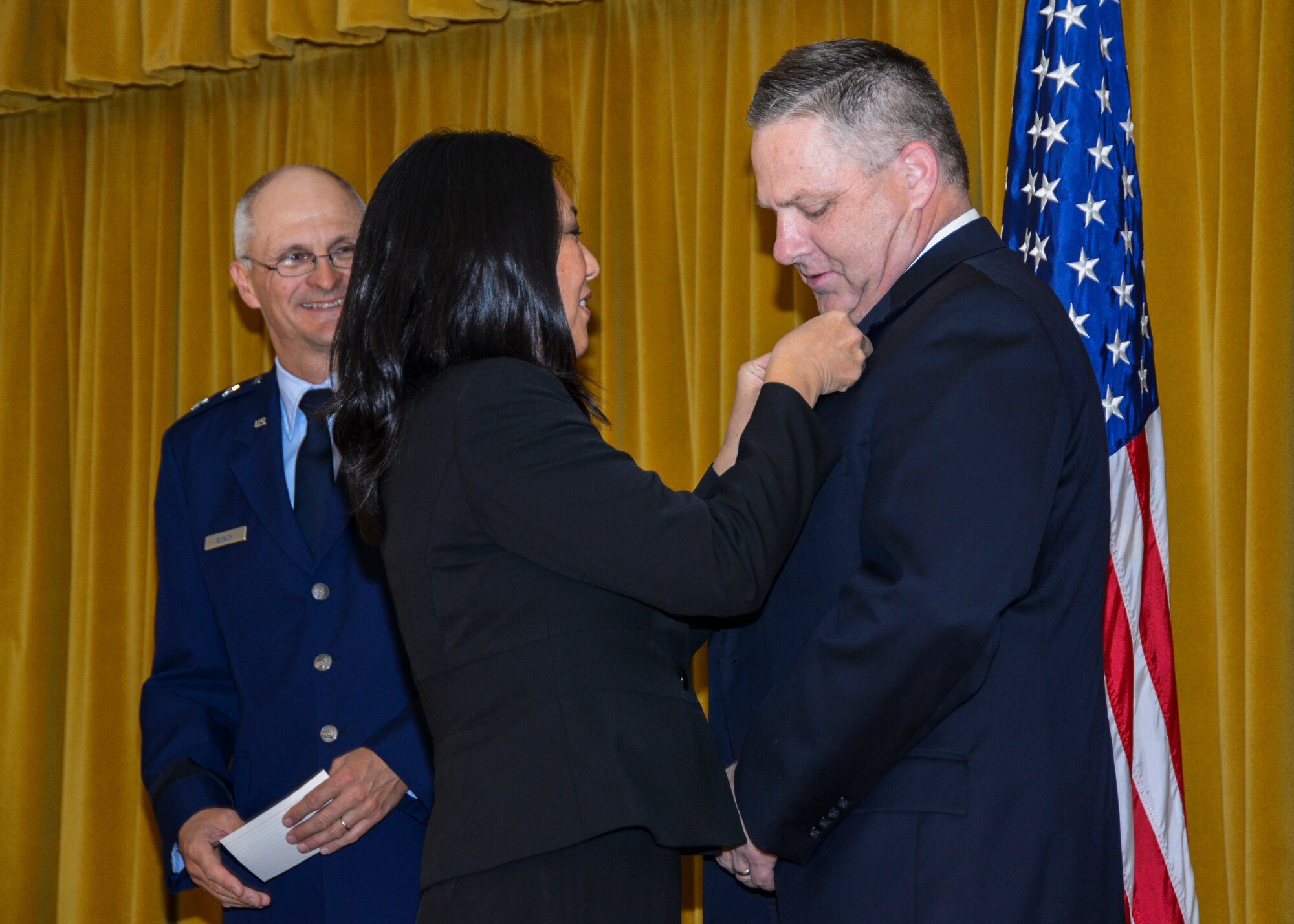 Dr. Joseph Nichols (right) receives his pin for Senior Level Service, pinned on by his wife Diane. The presiding officer for the ceremony was Maj. Gen. Arnold Bunch Jr., Commander of Air Force Test Center. (U.S. Air Force photo by Rebecca Amber)