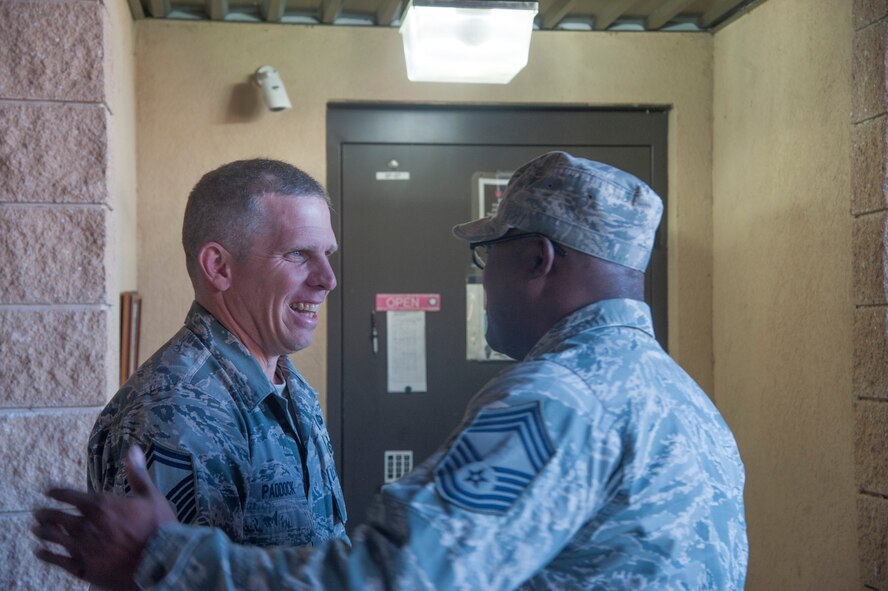 U.S. Air Force Chief Master Sgt. Brian Miller, 23d Logistics Readiness Squadron, congratulates Senior Master Sgt. Claude Paddock III, 820th Combat Operations Squadron, on his selection for promotion to chief master sergeant at Moody Air Force Base, Ga., Nov. 14, 2013.  (U.S. Air Force photo by Airman Dillian Bamman/Released)