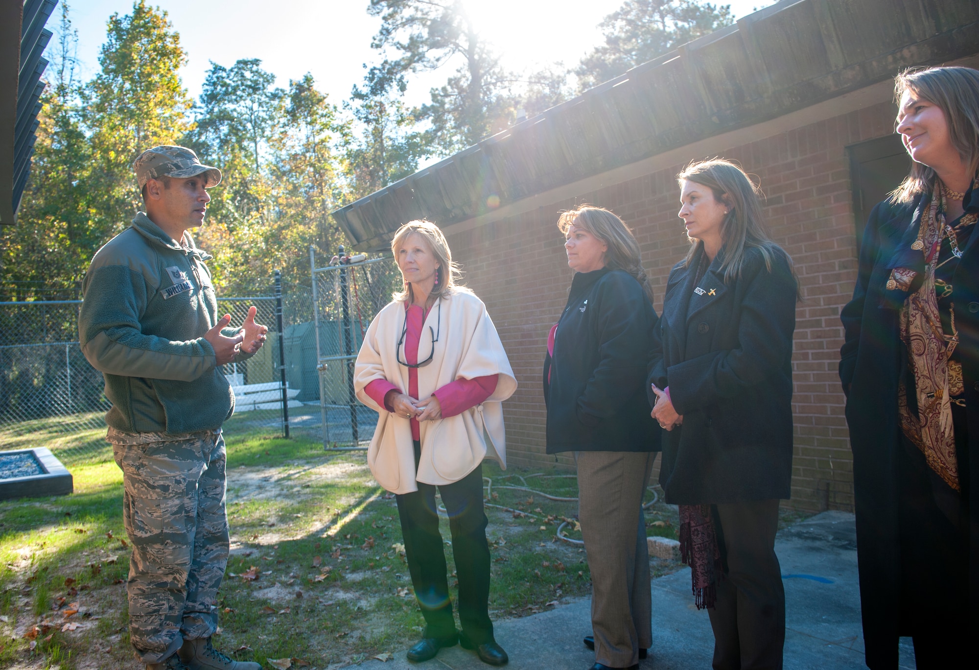 A military working dog handler answers questions during a K-9 demonstration at Moody Air Force Base, Ga., Nov. 13, 2013. The spouses of Moody and Ninth Air Force leadership toured the base as part of a visit by Maj. Gen. Jake Polumbo, 9th AF commander, and Chief Master Sgt. Scott Fuller, 9th AF command chief. (U.S. Air Force photo by Senior Airman Jarrod Grammel/Released)
