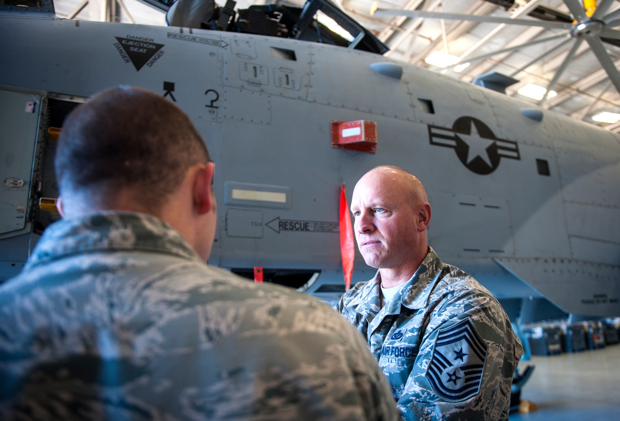 U.S. Air Force Chief Master Sgt. Scott Fuller, Ninth Air Force command chief, listens to Airmen talk about the A-10C Thunderbolt II at Moody Air Force Base, Ga., Nov. 13, 2013. Fuller and Maj. Gen. Jake Polumbo, Ninth Air Force commander, visited Moody Nov. 12 to 14. (U.S. Air Force photo by Senior Airman Jarrod Grammel/Released)

