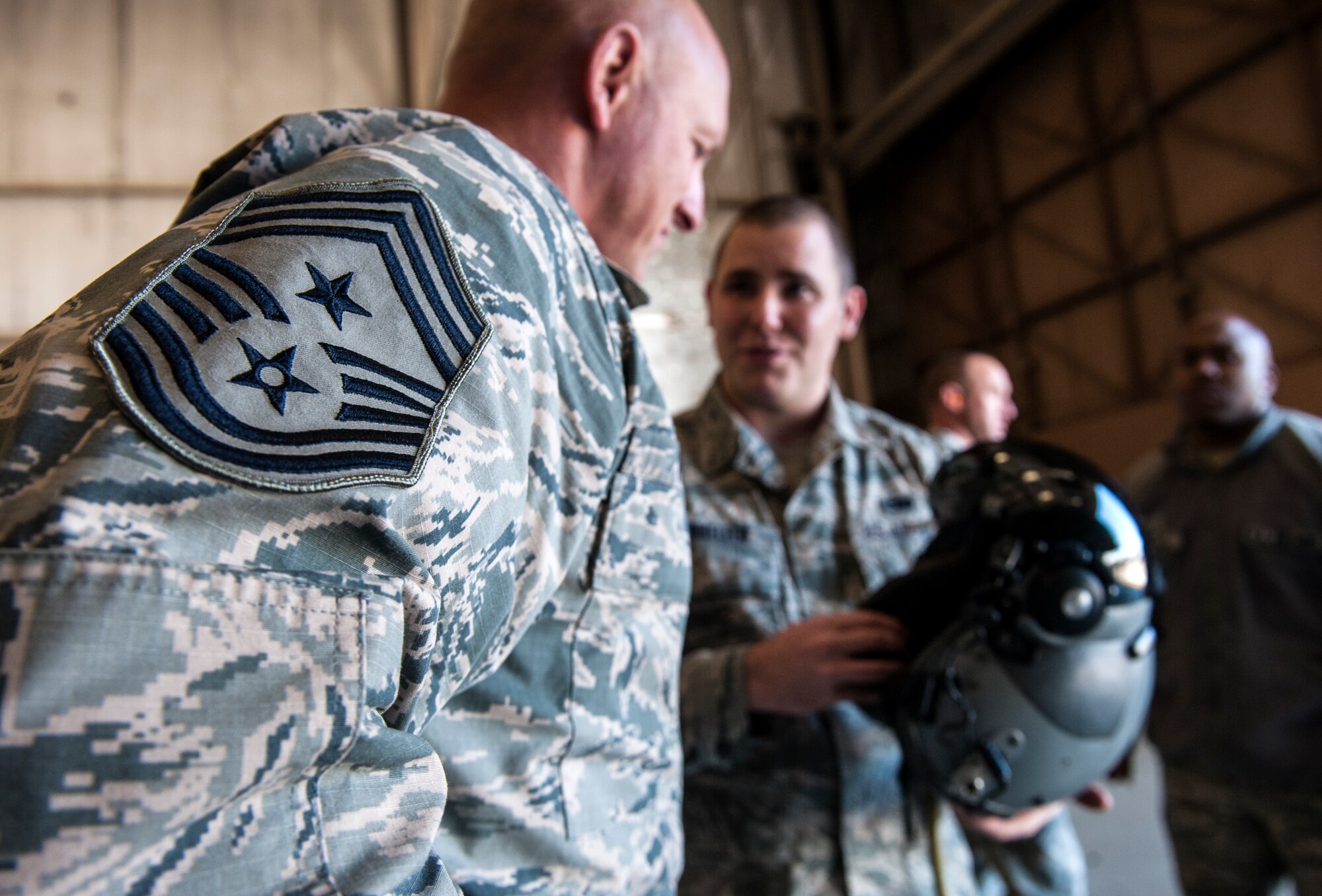 U.S. Air Force Senior Airman Ronald Steinhelfer, 23d Aircraft Maintenance Squadron avionics journeyman, talks to Chief Master Sgt. Scott Fuller, Ninth Air Force command chief, about the Helmet Mounted Cueing System at Moody Air Force Base, Ga., Nov. 13, 2013. Pilots with the 74th Fighter Squadron were the first to use the helmets for the A-10C Thunderbolt II. (U.S. Air Force photo by Senior Airman Jarrod Grammel/Released)
