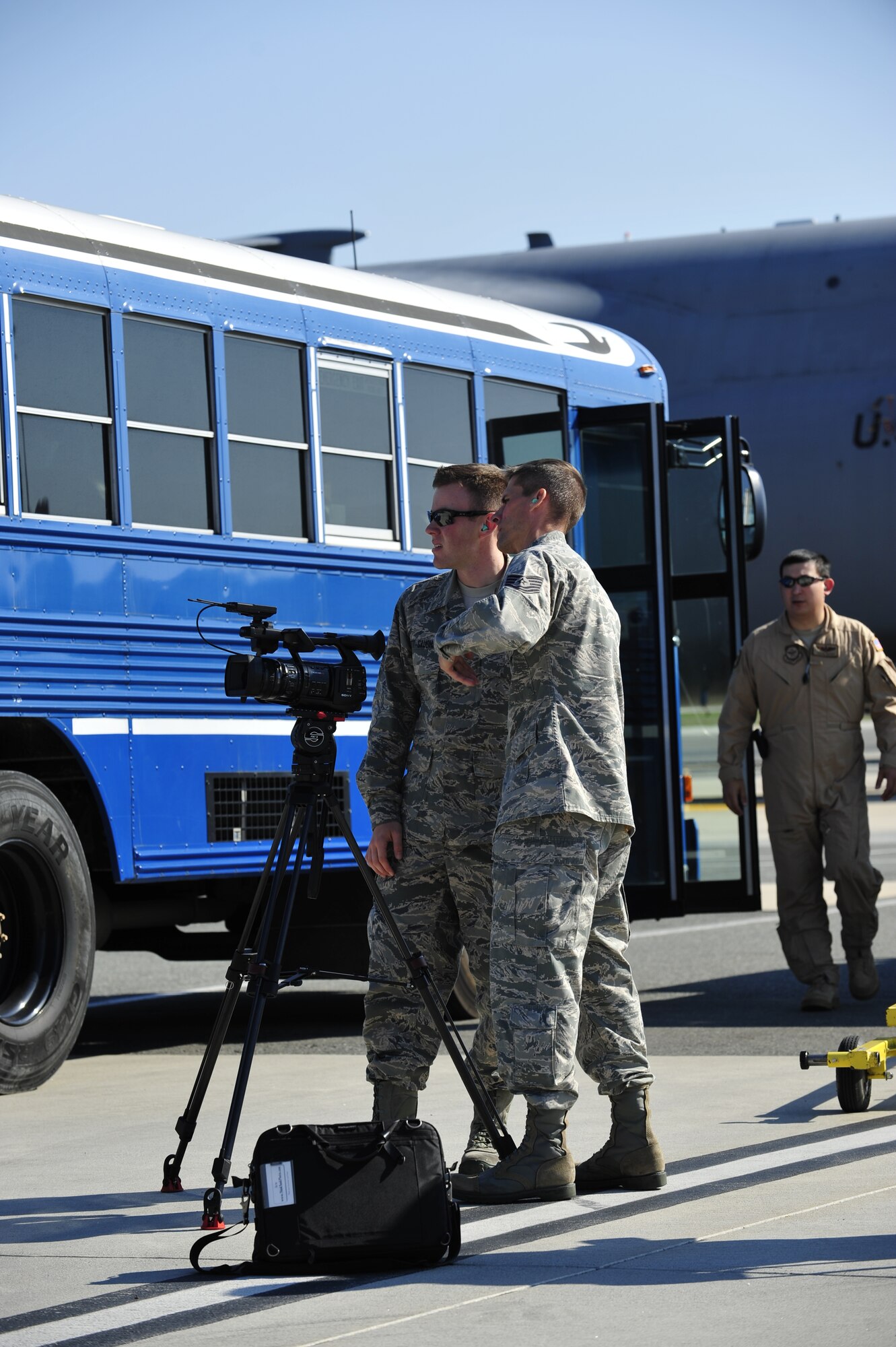 Tech. Sgt. Dale Gosney, 436th Airlift Wing Public Affairs NCO in charge of video operations, trains Airman 1st Class David Scott-Gaughan, 436th AW PA video operator, Oct. 29, 2013, at Dover Air Force Base, Del. Gosney and Scott-Gaughan filmed members of the 436th Aerial Port Squadron as they unloaded a CH-47D Chinook helicopter from a C-5M Super Galaxy. (U.S. Air Force photo/Airman 1st Class William Johnson)