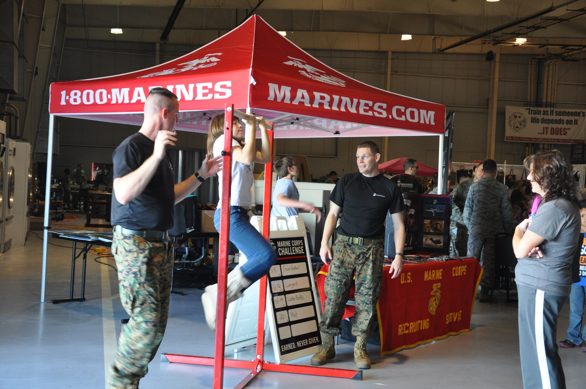 GOODFELLOW AIR FORCE BASE, Texas- A the 5th Annual Goodfellow Community Appreciation Day attendee attempts pull-ups at the Marine Corps recruiters’ booth at the Louis F. Garland Department of Defense Fire Academy Nov. 18. The event featured demonstrations from Team Goodfellow, a drill competition and more. (U.S. Air Force photo/ Airman 1st Class Erica Rodriguez)