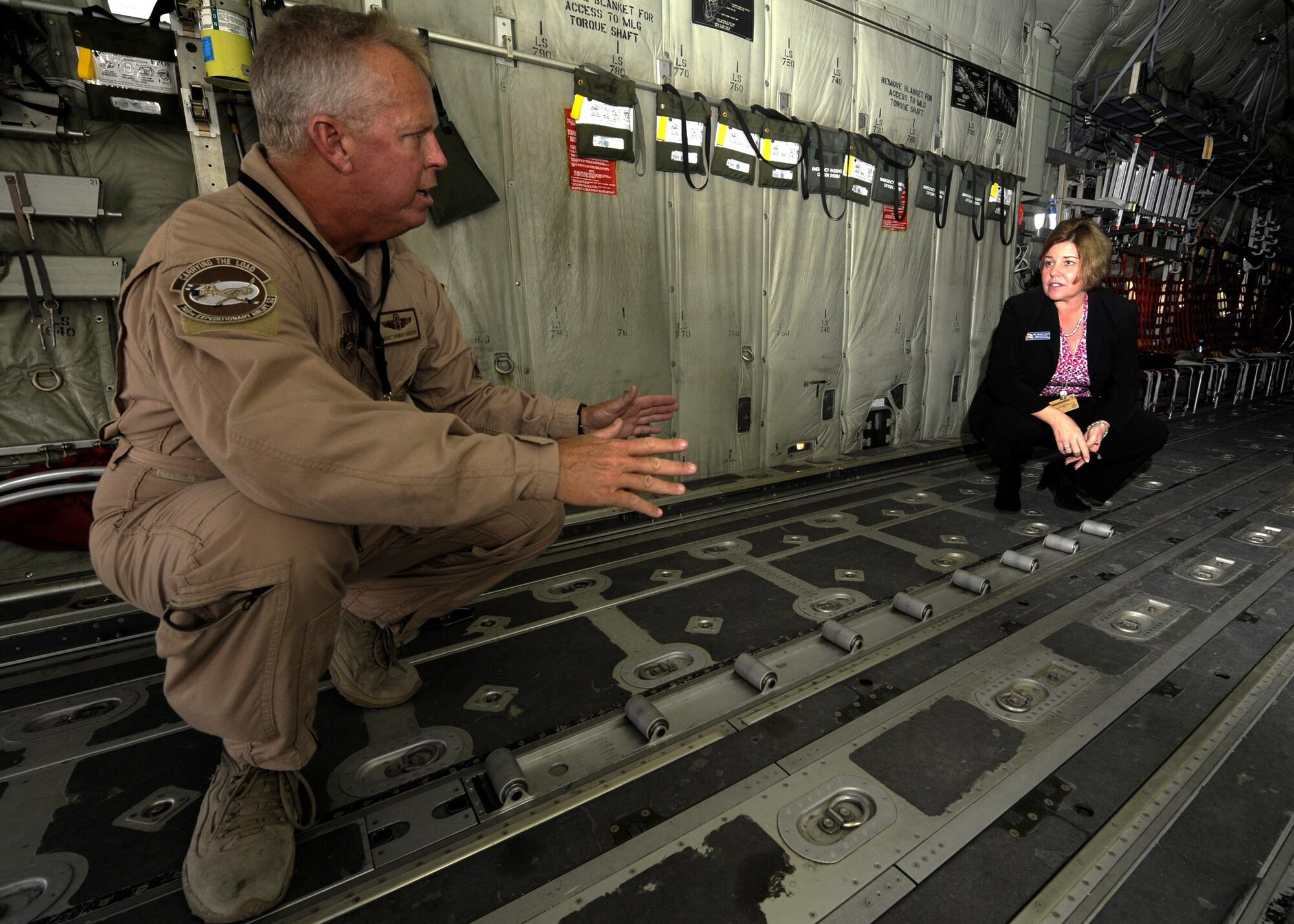 Senior Master Sgt. Thomas Maddock shows Ms. Heidi Grant features on the C-130J during the 2013 Dubai Airshow at the Dubai World Central airport in Jebel Ali, Nov. 18, 2013. Maddock is a C130J loadmaster deployed from Keesler Air Force Base, Miss., and a Navarre, Fla., native. Grant is the deputy undersecretary of the Air Force for International Affairs. (U.S. Air Force photo/Senior Airman Bahja J. Jones)