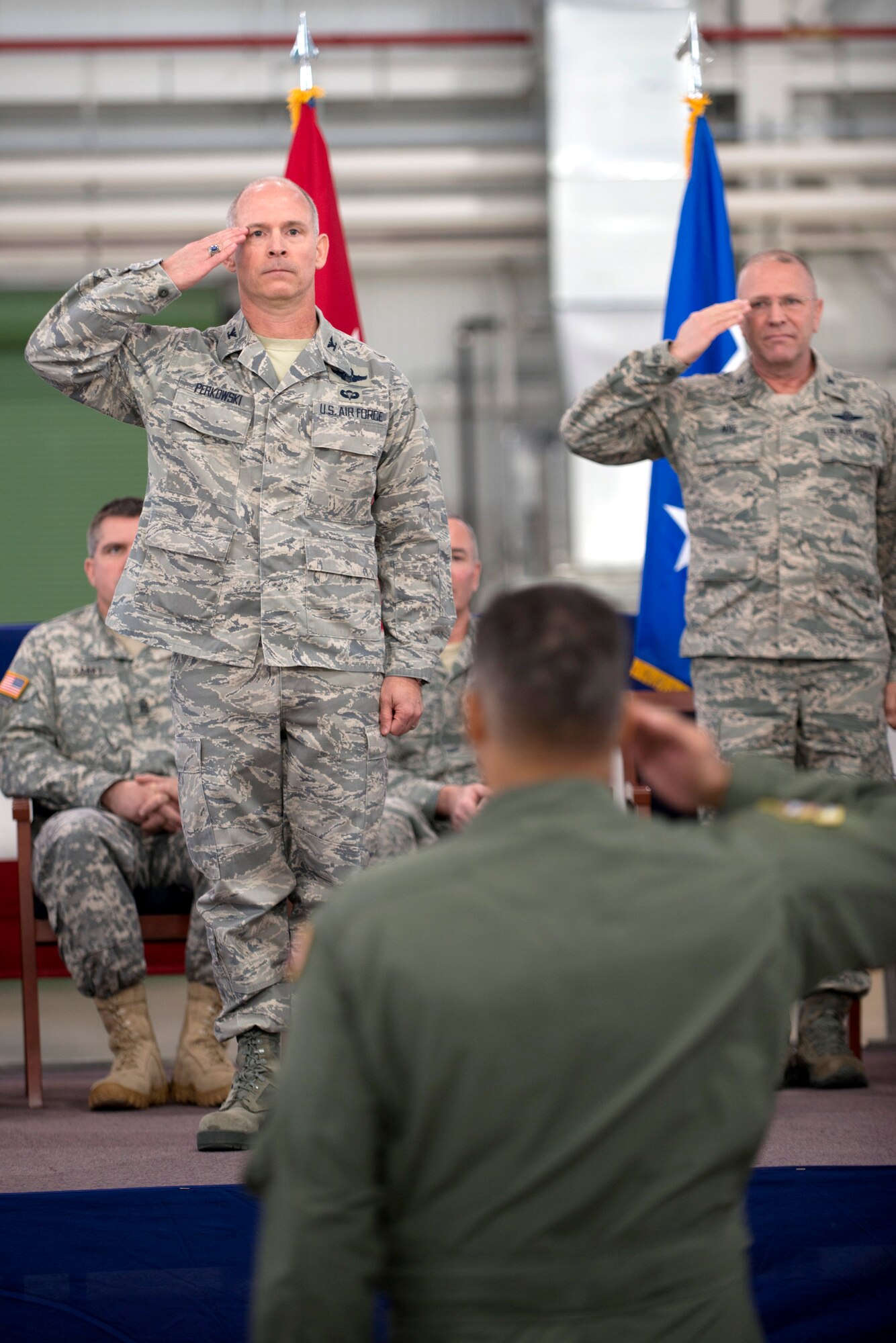 Col. Shaun Perkowski, left, incoming commander for the 167th Airlift Wing, renders his first official salute as commander during the change of command ceremony, Nov. 15. Outgoing commander, Col. Roger Nye, right, is retiring after 35 years of service, the last six of which he served as commander of the 167AW. (Air National Guard photo by: Master Sgt. Emily Beightol-Deyerle)