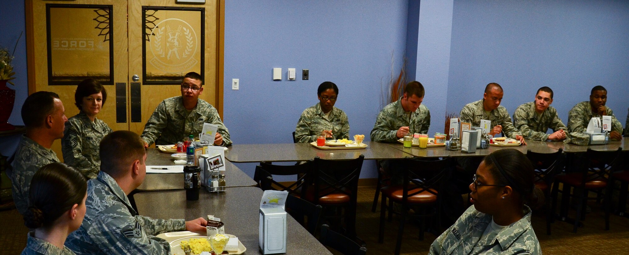 U.S. Air Force Col. Kevin Blanchard, 355th Fighter Wing commander, and Chief Master Sgt. Dawna  Cnota, 355th Fighter Wing command chief, talk with Airmen during a Chief Breakfast at Davis-Monthan Air Force Base, Ariz., Nov. 12, 2013. Cnota hosts the Chief’s Breakfast, a bi-monthly informal meeting, to provide guidance to younger Airmen with any work-related or personal problems. (U.S. Air Force photo by Senior Airman Sivan Veazie/Released) 
