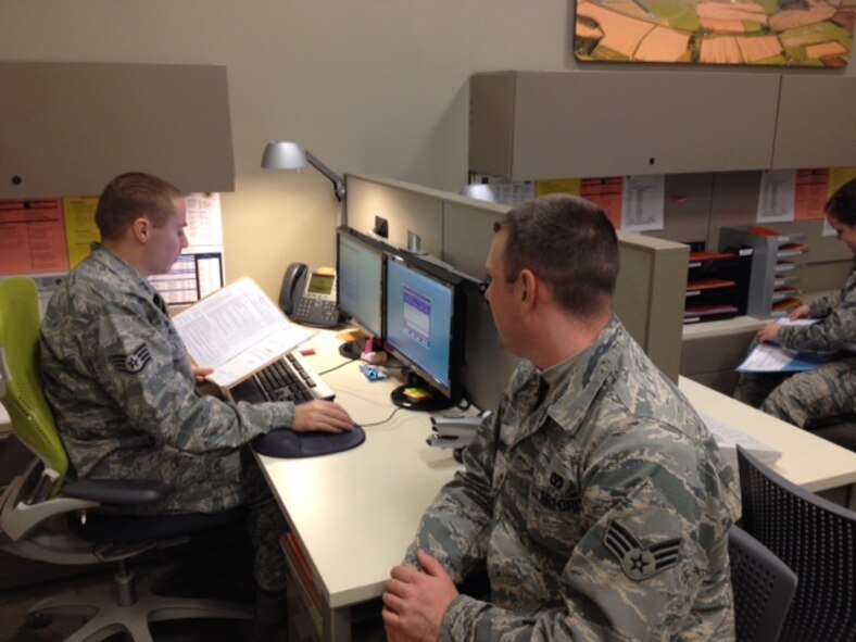 U.S. Air Force Staff Sgt. Mathew Alexander, left, 509th Force Support Squadron NCO in charge of re-enlistments, assists Senior Airman Barry Fellows, 509th Civil Engineer Squadron waters and fuel systems maintenance journeyman, with his customer service needs at the new FSS building, Whiteman Air Force Base, Mo., Nov. 13, 2013. All sections of the 509th FSS were combined to serve the Airmen conveniently and efficiently. (U.S. Air Force photo by Airman 1st Class Keenan Berry/Released)