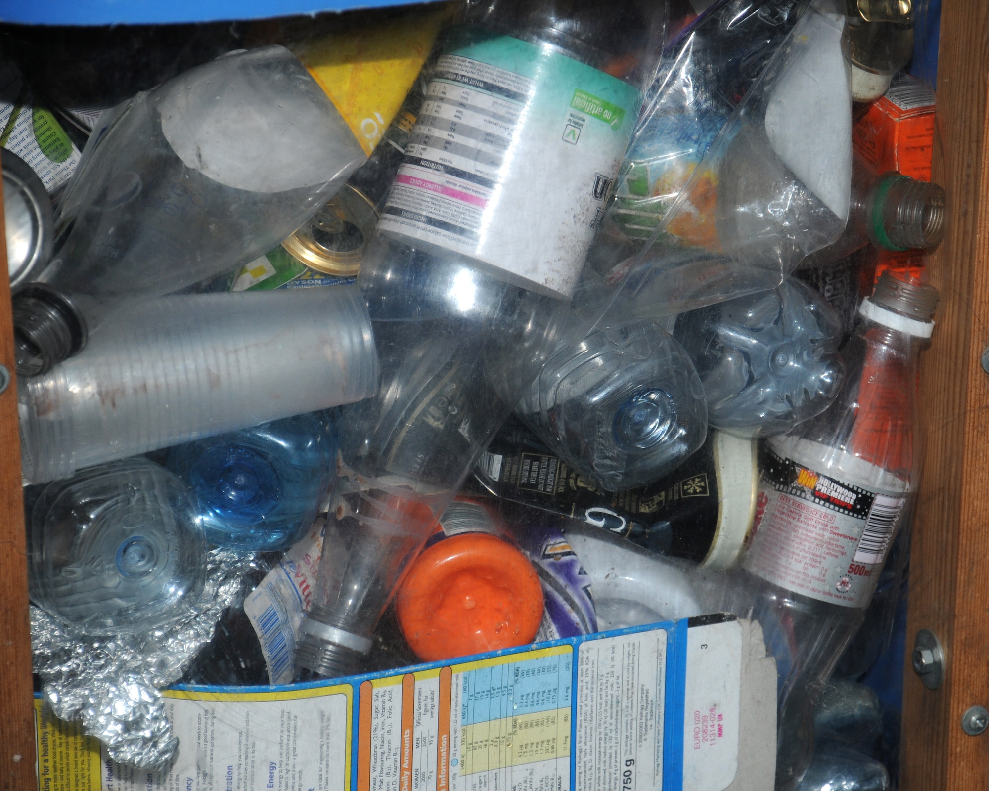 A blue bin is filled with recyclable items to demonstrate to Team Mildenhall members and their families how to recycle their household waste effectively Nov. 15, 2013, at the BXtra on RAF Mildenhall, England. The St. Edmundsbury and Forest Heath District Councils and the 100th Civil Engineer Squadron Environmental shop representatives spent the day informing people what items can and cannot be recycled. The representatives explained how items such as paper, aluminum, steel, and plastic bottles and containers are able to be recycled using the blue bin. (U.S. Air Force photo by Gina Randall/Released)