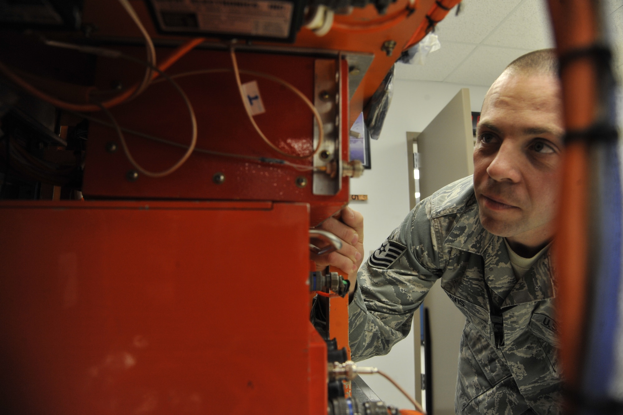 U.S. Air Force Tech. Sgt. Nathan Davis, 72nd Test and Evaluation Squadron maintenance system evaluator, inspects area racks at Whiteman Air Force Base, Mo., Oct. 29, 2013. Engineers across the Air Force use area racks to record data from the aircraft to see how it functions daily. (U.S. Air Force photo by Airman 1st Class Keenan Berry/Released)