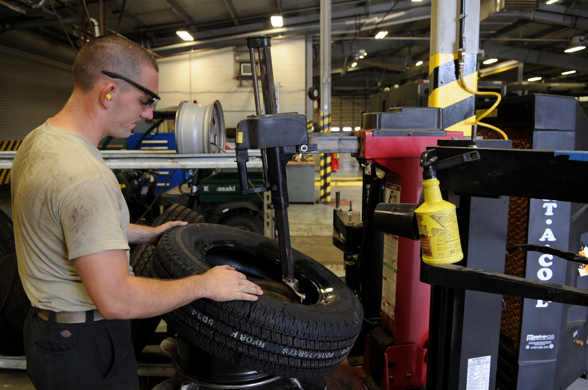 Senior Airman Charles Whitney, a 19th Logistics Readiness Squadron vehicle and vehicular equipment maintenance journeyman, fixes a tire Sept. 11, 2013, at Little Rock Air Force Base, Ark. The vehicle management flight uses a re-tread tire program as part of a green procurement initiative. (U.S. Air Force photo by Staff Sgt. Caleb Pierce)