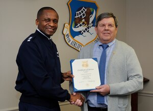 Lt. Gen. Darren W. McDew awards the 50 Years of Civil Service pin to John, R. Botwinick at the 89th Communications Squadron on Joint Base Andrews, Md., Nov. 18, 2013.  Botwinick retired from the Air Force after 23 years, and in 1985 went on to work as a federal employee. McDew is the 18th Air Force commander and Botwinick is a 89th Communications Squadron, mission systems flight chief. (U.S. Air Force photo/Airman 1st Class Nesha Humes)