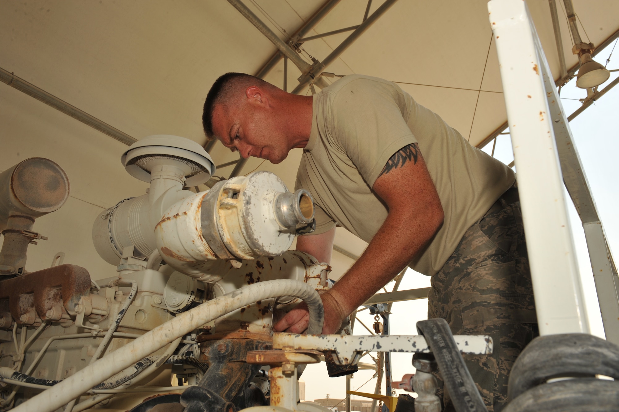 Tech. Sgt. Jim Erwin replaces a water trucks water pump outer piping after discovering a leak in Southwest Asia, Nov. 7, 2013. Erwin is the 379th Expeditionary Logistics Readiness Squadron special purpose teams NCO in charge who oversees the repairs of mission essential vehicles and high use vehicles and is deployed from Whiteman Air Force Base, Mo., and a Trenton, Ill., native. (U.S. Air Force photo/Master Sgt. David Miller)