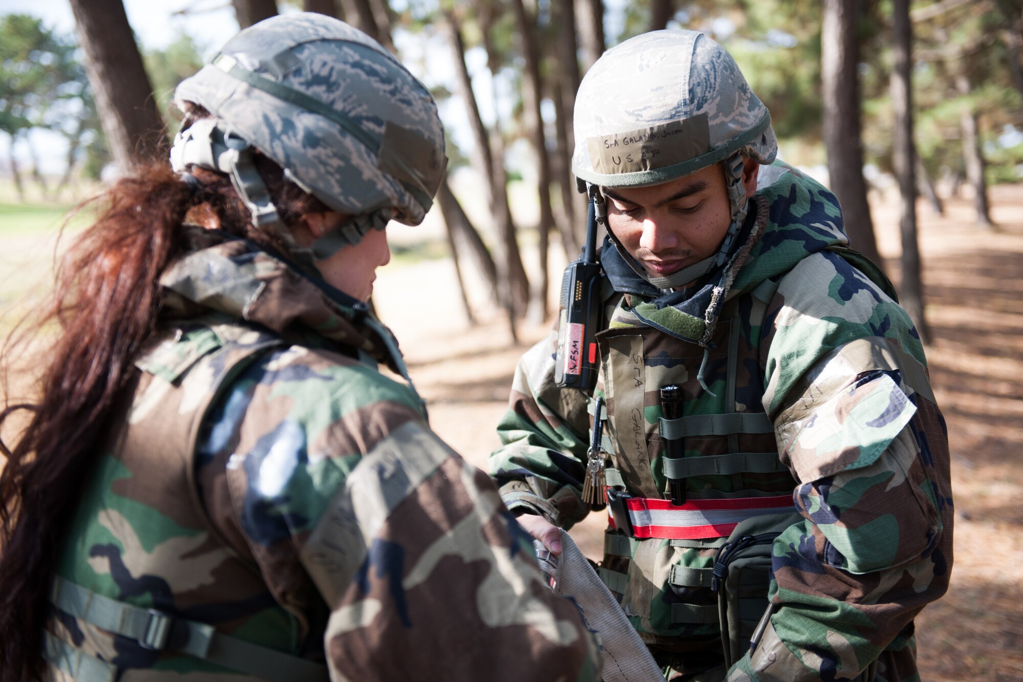 Senior Airman Jason Galang, 8th Civil Engineer Squadron water fuel systems maintenance technician, right, connects two hoses for a filtration system during Beverly Bulldog 14-01 at Kunsan Air Base, Republic of Korea, Nov. 19, 2013. Airmen from the 8th CES tested their ability to provide clean and potable water to the Wolf Pack. The 8th Fighter Wing is testing its wartime mission alongside other 7th Air Force units and supporting organizations with an emphasis on the operational and tactical levels of war during the peninsula-wide exercise. (U.S. Air Force photo by Senior Airman Armando A. Schwier-Morales)
