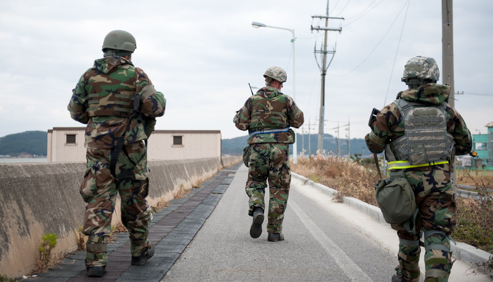 Airmen from the 8th Security Forces Squadron and 8th Civil Egineer Squadron ensure the security of an off-base facility during exercise Beverly Bulldog 14-01 at Gunsan City, Republic of Korea, Nov. 19, 2013. The 8th Fighter Wing is testing its wartime mission alongside other 7th Air Force units and supporting organizations with an emphasis on the operational and tactical levels of war during the peninsula-wide exercise. (U.S. Air Force photo by Senior Airman Armando A. Schwier-Morales/Released)