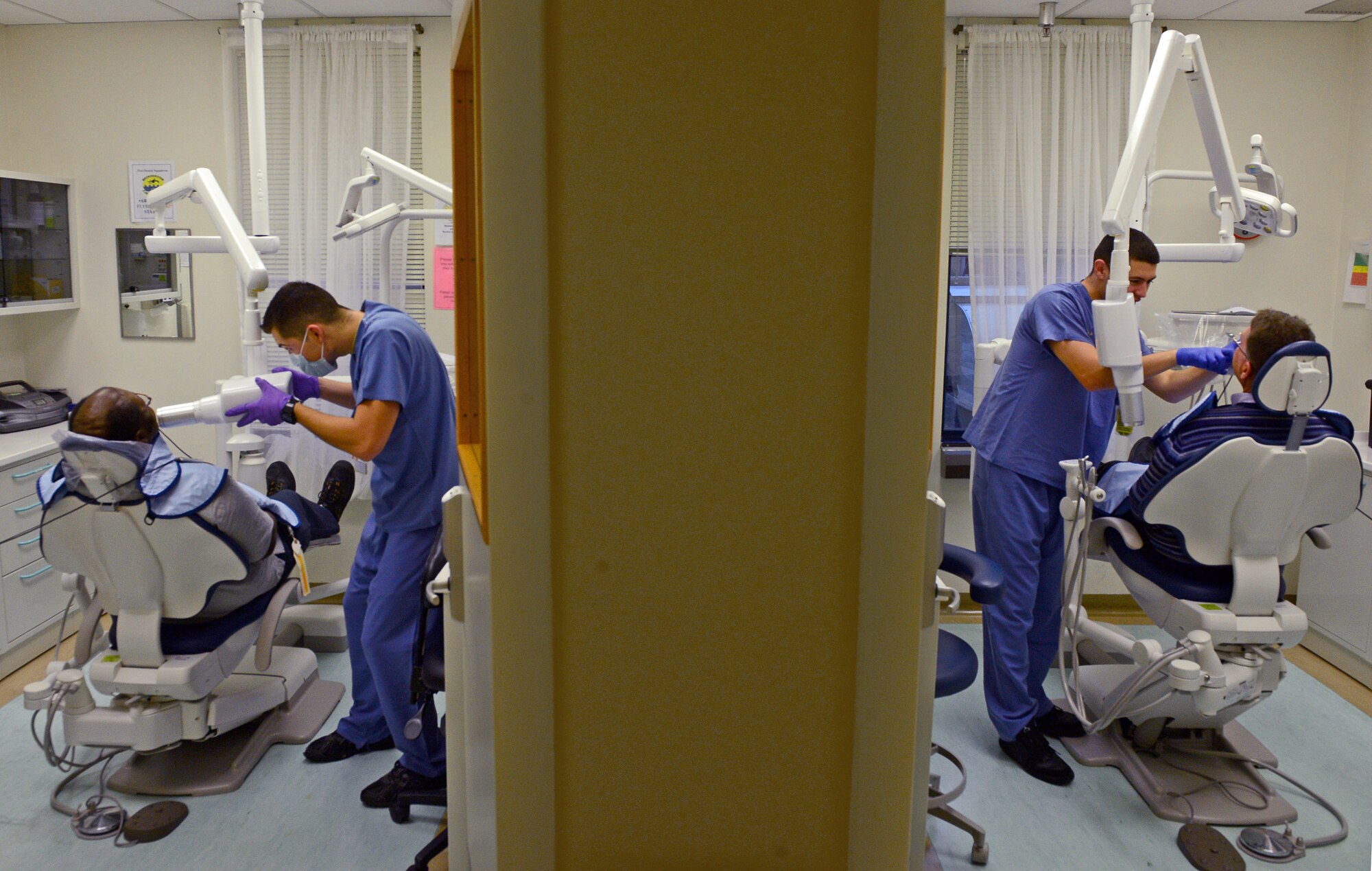 Dental technicians from the 31st Dental Squadron care for patients during Retiree Appreciation Day, Nov. 15, 2013, at Aviano Air Base, Italy. The 31st DS reserved the day for retirees and provided services that they would normally be seen on space available or emergency basis. (U.S. Air Force photo/Senior Airman Matthew Lotz)