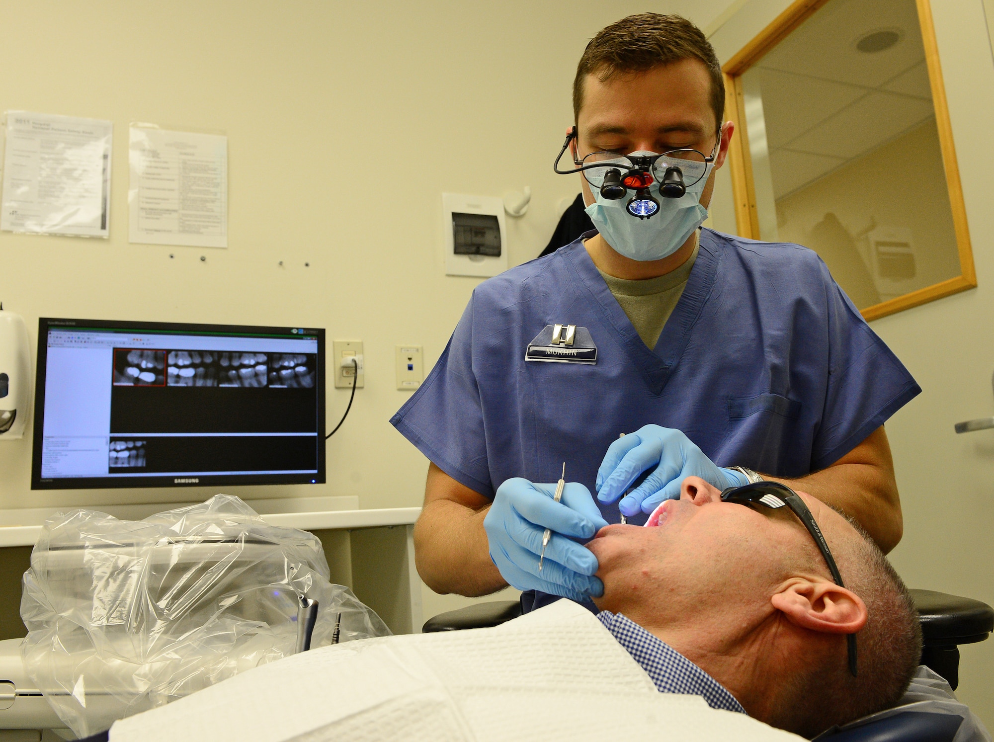 Capt. Mikhail Mukhin, 31st Dental Squadron dentist, inspects a retiree’s teeth during Retiree Appreciation Day, Nov. 15, 2013, at Aviano Air Base, Italy. The 31st DS scheduled more than 50 veterans to receive free dental services to include examinations, x-rays and cleanings for Retiree Appreciation Day. (U.S. Air Force photo/Senior Airman Matthew Lotz)
