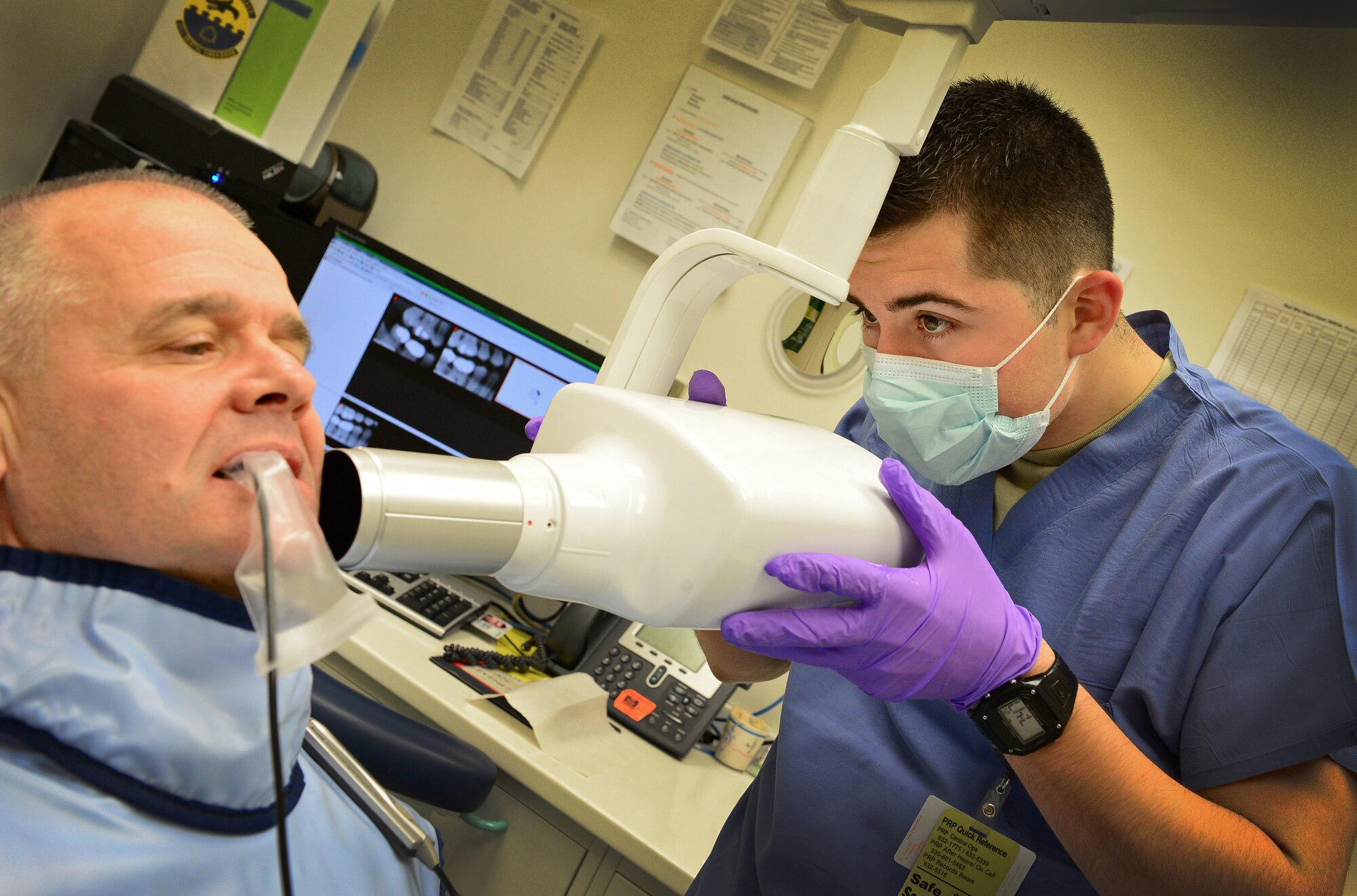 Airman 1st Class Edward Urtiaga, 31st Dental Squadron technician, x-rays retired Col. Dennis Pearman’s teeth during Retiree Appreciation Day, Nov. 15, 2013, at Aviano Air Base, Italy. The 31st DS scheduled more than 50 veterans to receive free dental services to include examinations, x-rays and cleanings for Retiree Appreciation Day. (U.S. Air Force photo/Senior Airman Matthew Lotz)