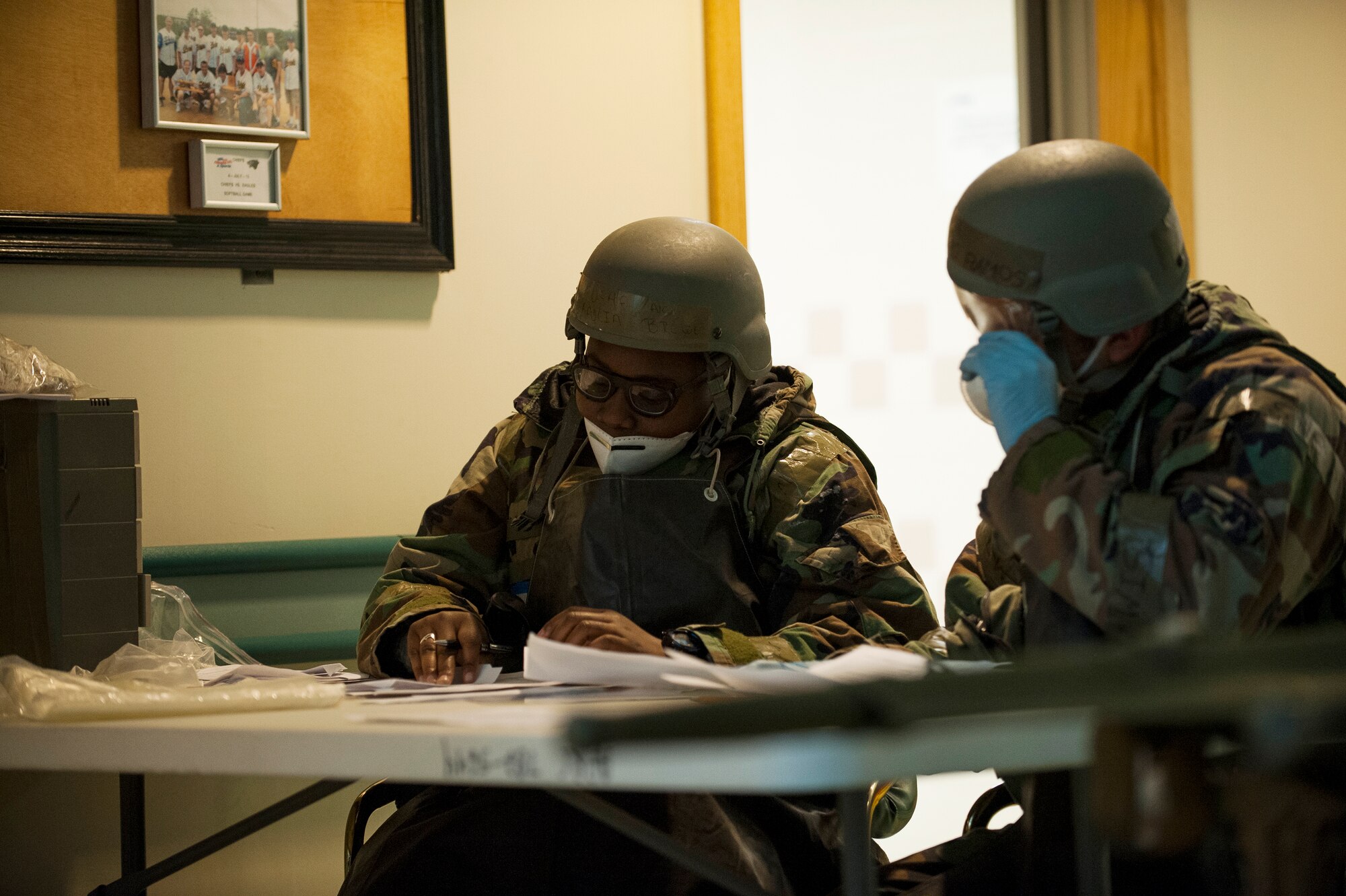 Airman 1st Class Kaylia Brewer and Staff Sgt. Alejandro Ramos, 8th Force Support Squadron, process paperwork for a simulated casualty during Exercise Beverly Bulldog 14-01 at Kunsan Air Base, Republic of Korea, Nov. 19, 2013. Exercise Beverly Bulldog 14-01 demonstrates and enhances the readiness of 7th Air Force to defend and sustain the capabilities which strengthen the ROK-U.S. Alliance. (U.S. Air Force photo by Senior Airman Clayton Lenhardt/Released)