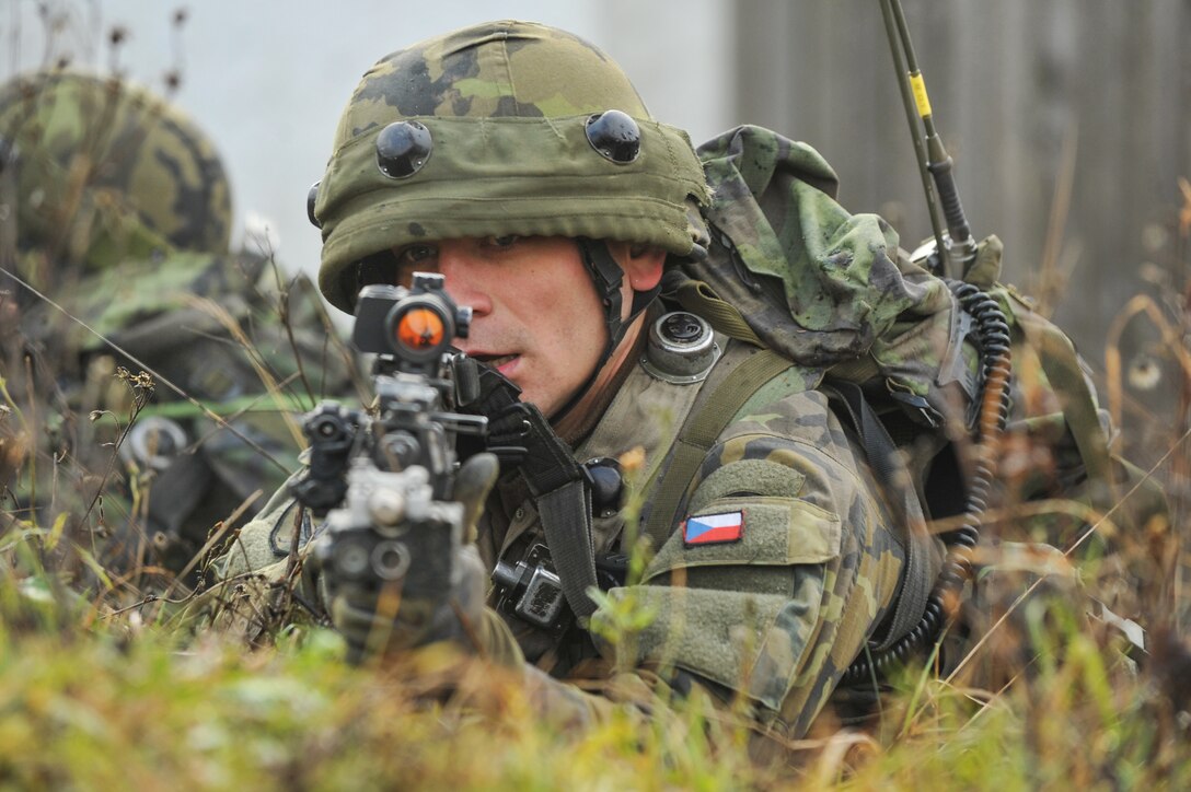 A Czech soldier provides cover while fellow soldiers conduct attack training during exercise Combined Resolve at the Joint Multinational Readiness Center, Hohenfels, Germany, Nov. 15, 2013.
