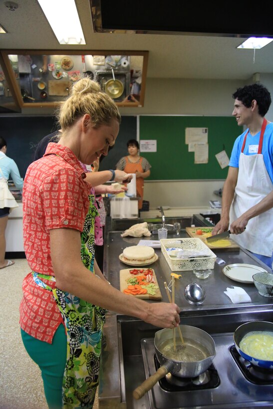 Summer Kehr, Japanese cooking class participant, prepares the fish broth soup for her group at the Iwakuni Fukushikaikan, Oct. 11, 2013. The fish broth soup also included small squares of tofu.