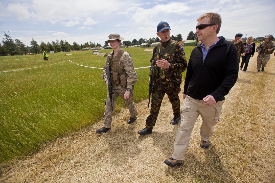 Wing Commander Darryl Cockroft, commanding officer of 209 Expeditionary Support Squadron, from Napier, New Zealand, talks to Dr. Jonathan Coleman, New Zealand Minister of Defence, during exercise Southern Katipo 2013 at Timaru Airfield, New Zealand, Nov. 15. SK13 allows our service members to collaborate with partner countries to achieve mutual security goals, address shared concerns and continue to enhance our interoperability. 