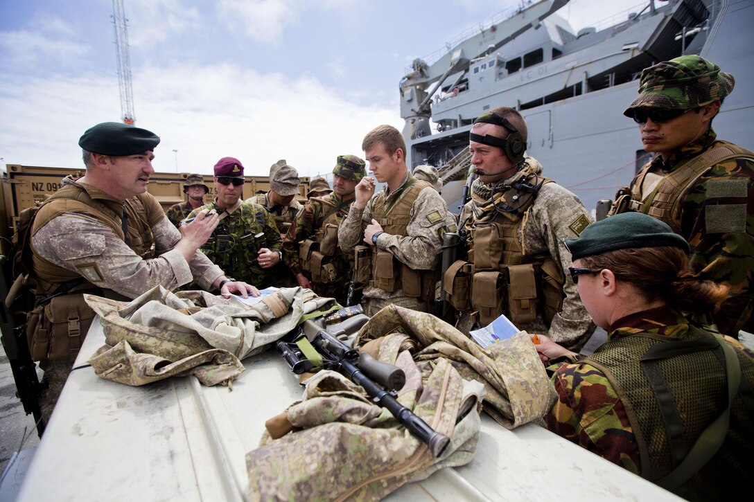 Capt. Gareth Collings, logistics advisor with 2 Engineer Regiment, from New Plymouth, New Zealand, gives a tactical movement brief during Phase I of exercise Southern Katipo 2013 aboard Timaru, New Zealand, Nov. 12. SK13 strengthens military to military relationships and cooperation with partner nations and the New Zealand Defence Force.  